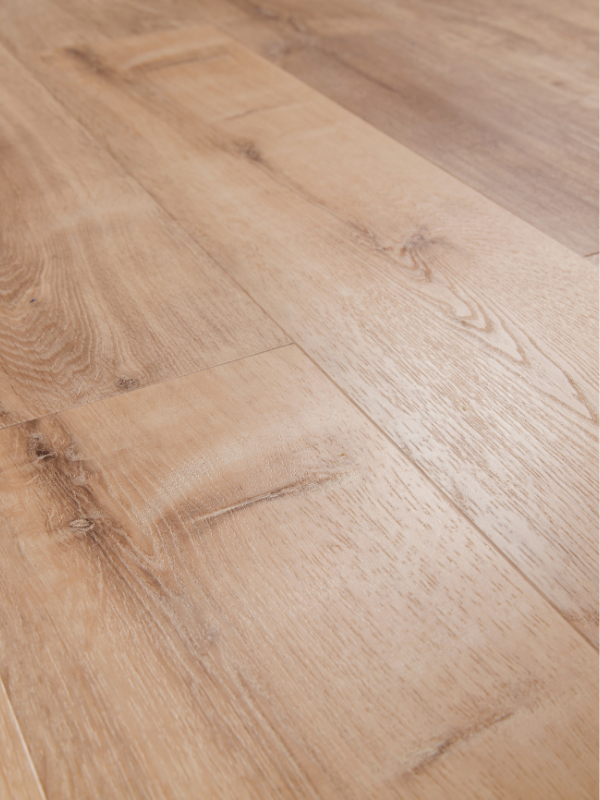 Close-up of a light-colored wooden floor with visible grain and knots.