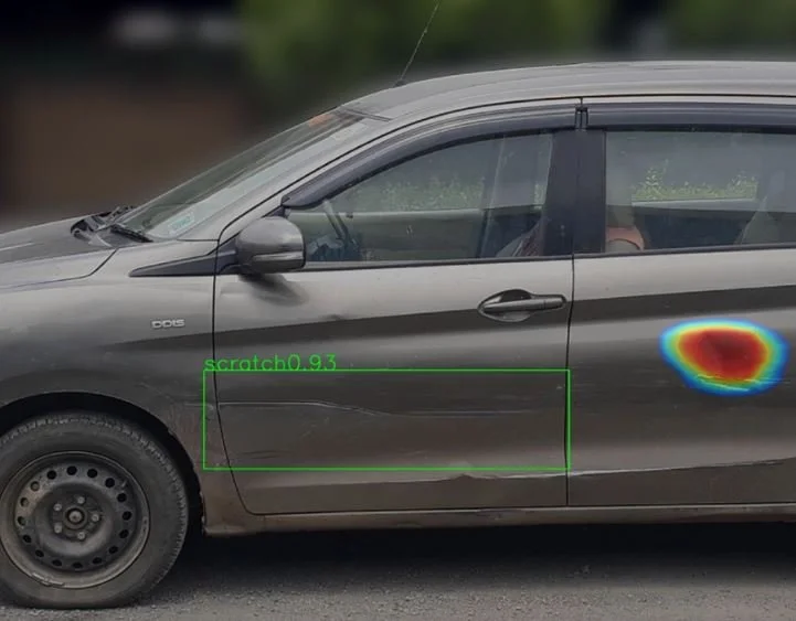 Side view of a gray car with a heat map spot on the rear door, showing an impact area; a green outline indicates a scratch or damage.