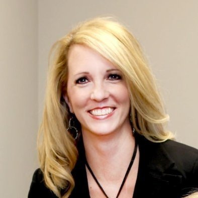 Smiling woman with long blonde hair wearing a black blazer.