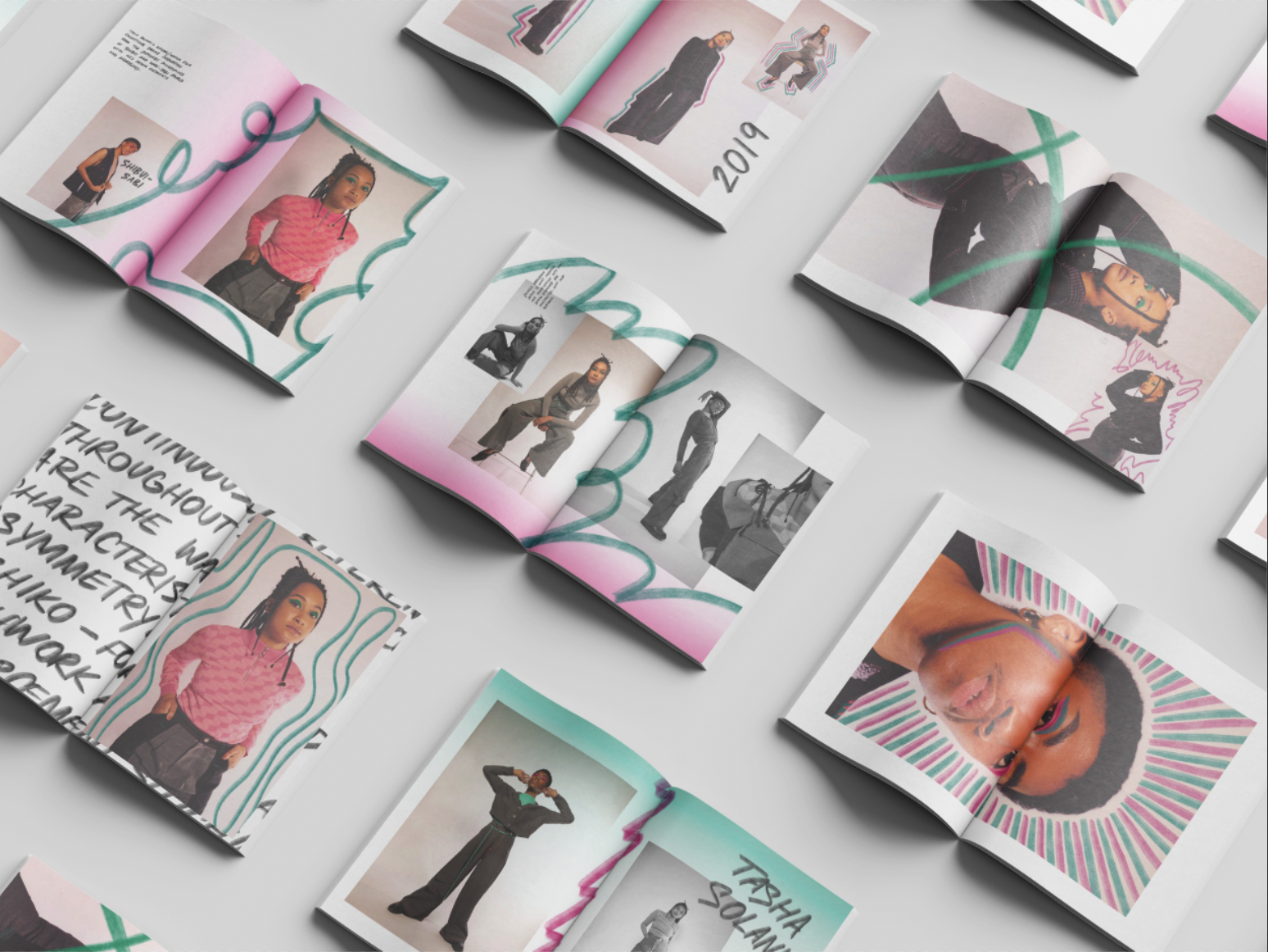 Open magazines with fashion photography and colorful designs.