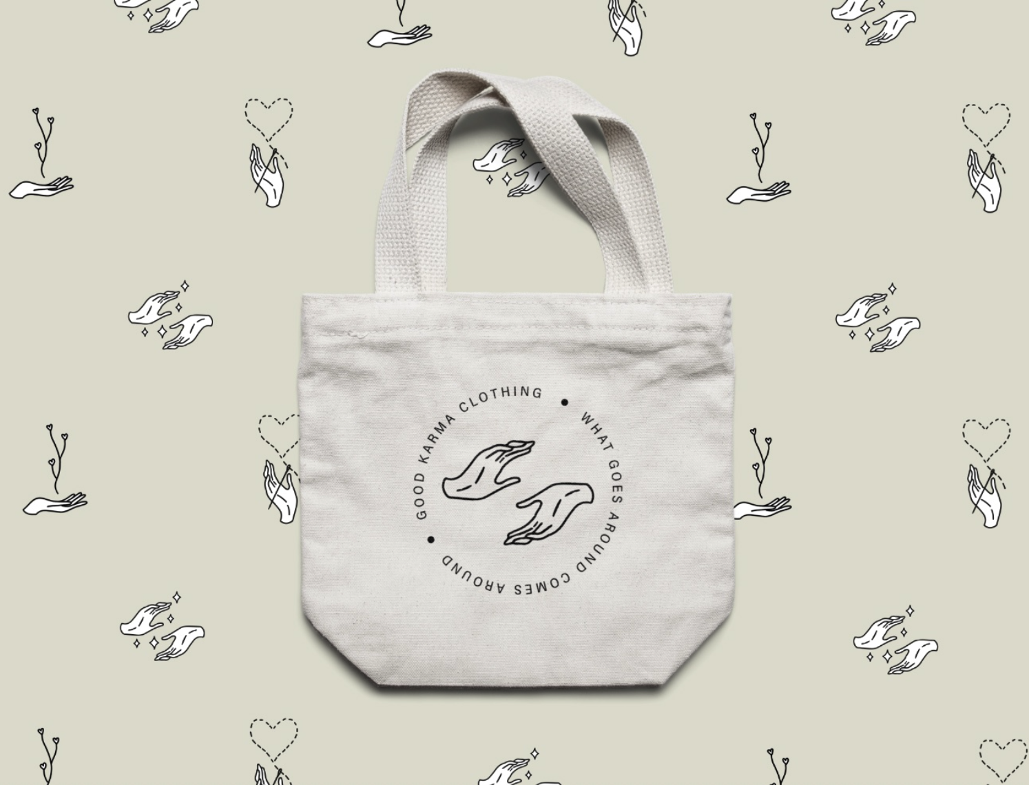 Canvas tote bag with "Good Karma Clothing" logo and graphics of hands on a patterned background.