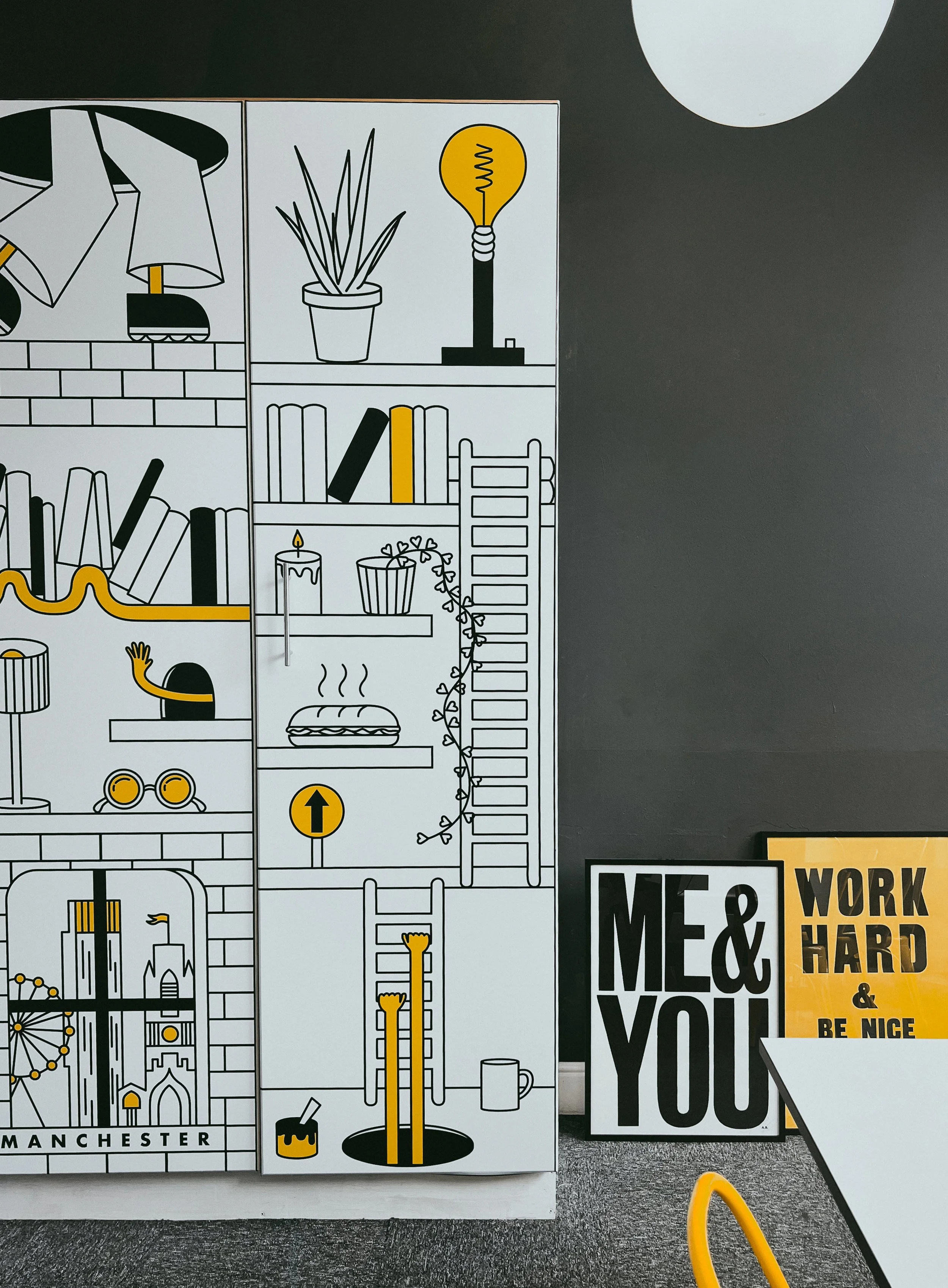Creative illustration featuring bookshelves with plants, books, a lamp, and decor items in black, white, and yellow. A ladder and whimsical details like a ladder descending into a hole and a steaming sandwich are depicted. Nearby, motivational signs 
