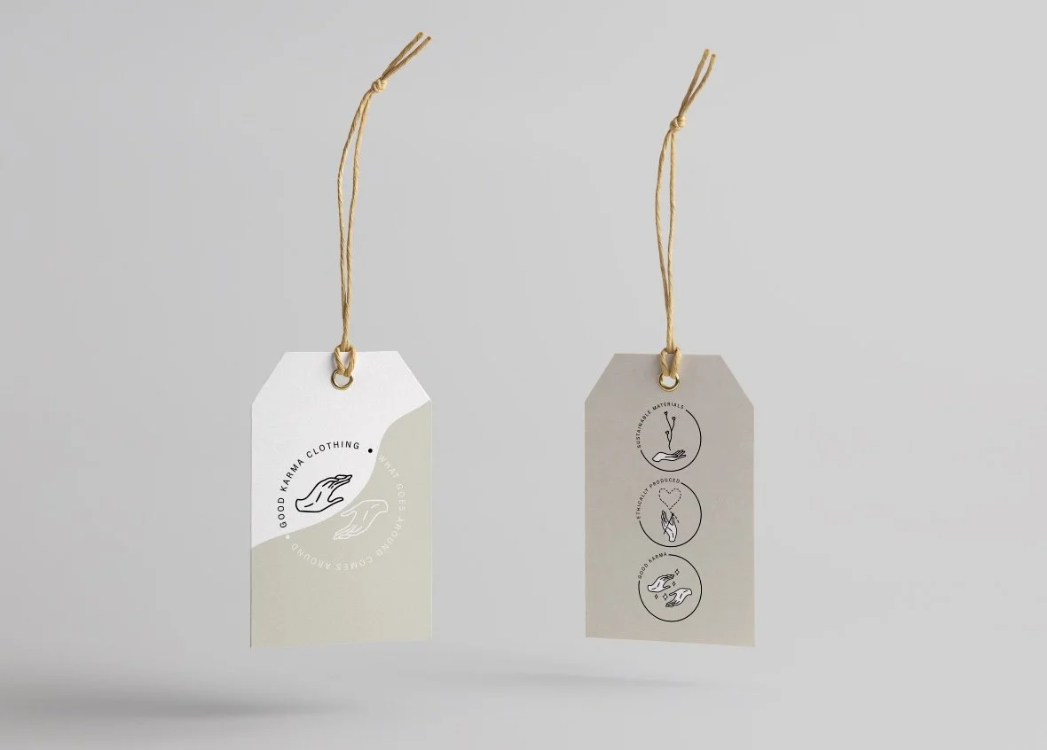 Two eco-friendly clothing tags with sustainable messaging; one displays "Good Karma Clothing" with hand graphics, and the other shows symbols for sustainable materials, ethically produced, and good karma.