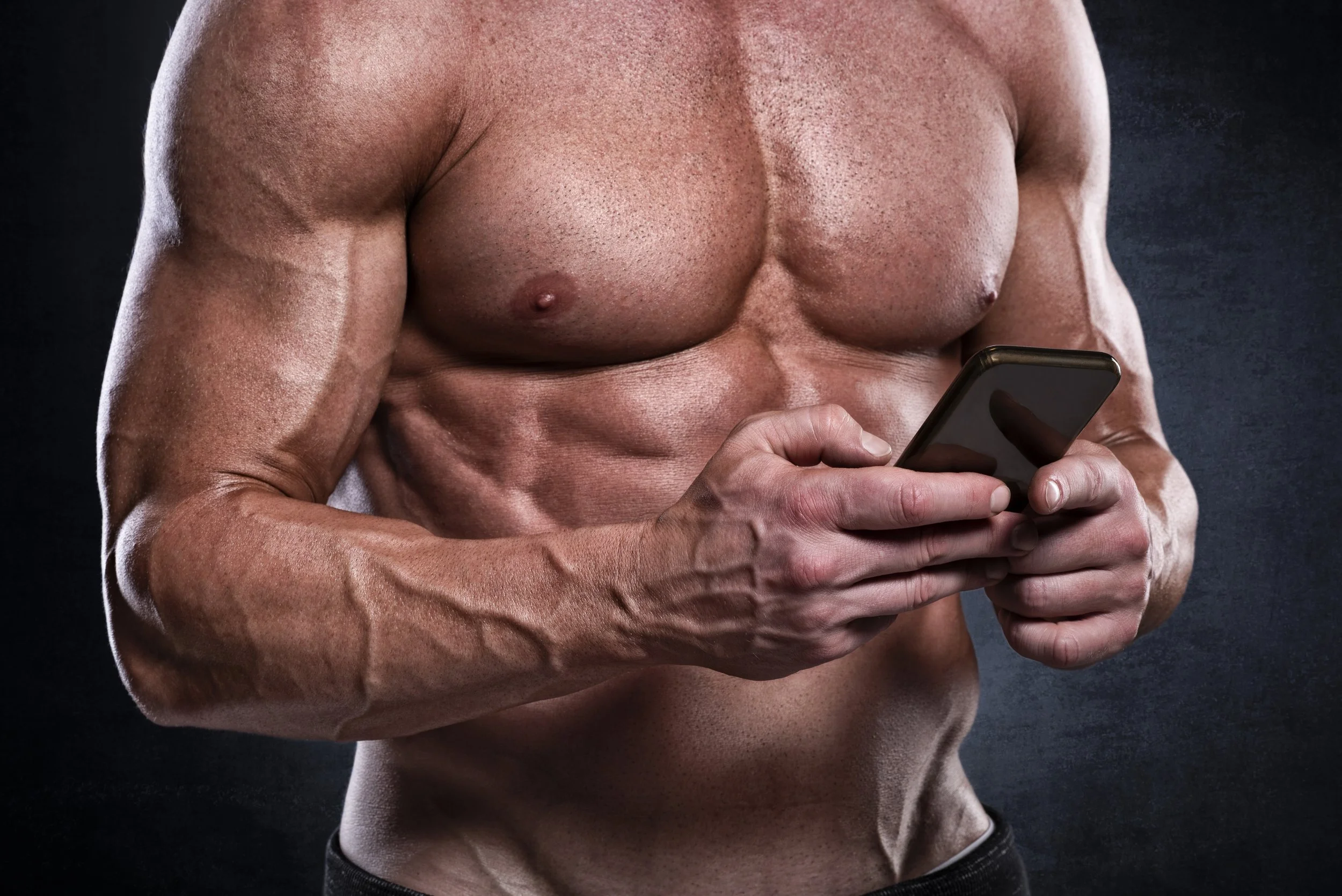 Man checking his personal training program on a phone, demonstrating a custom strength training plan
