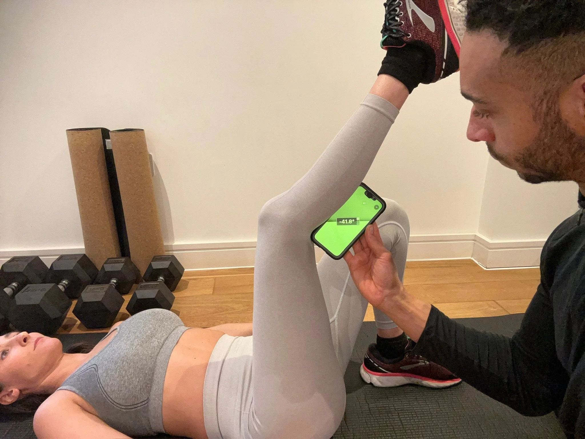 Movement screening using joint angle app to evaluate client posture and muscle balance in private studio