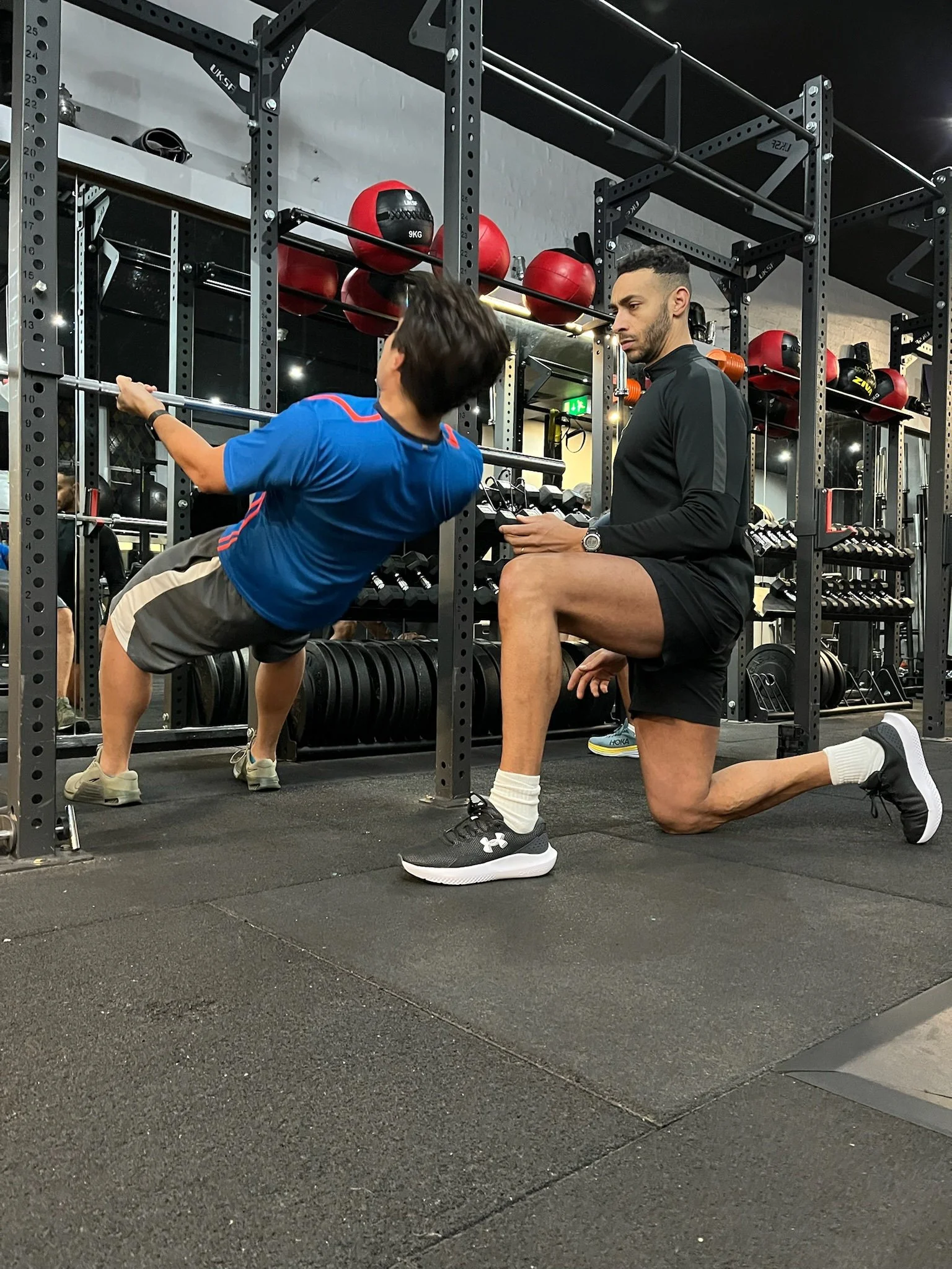 Personal trainer coaching a client in a private Central London studio