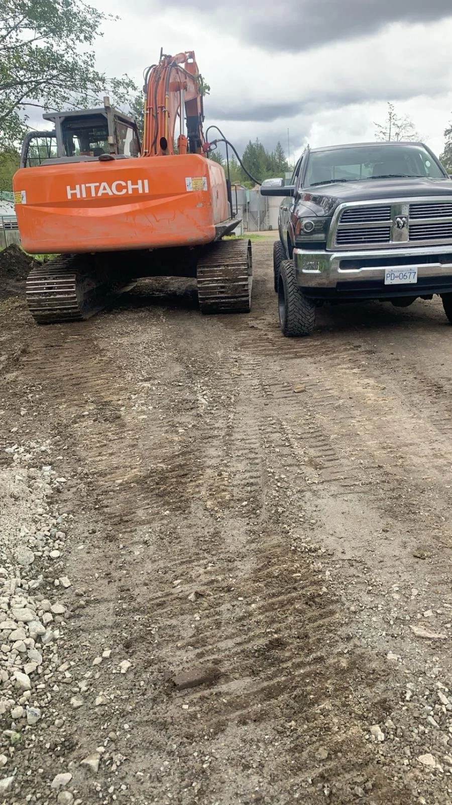 Excavator and pickup truck parked on a construction site