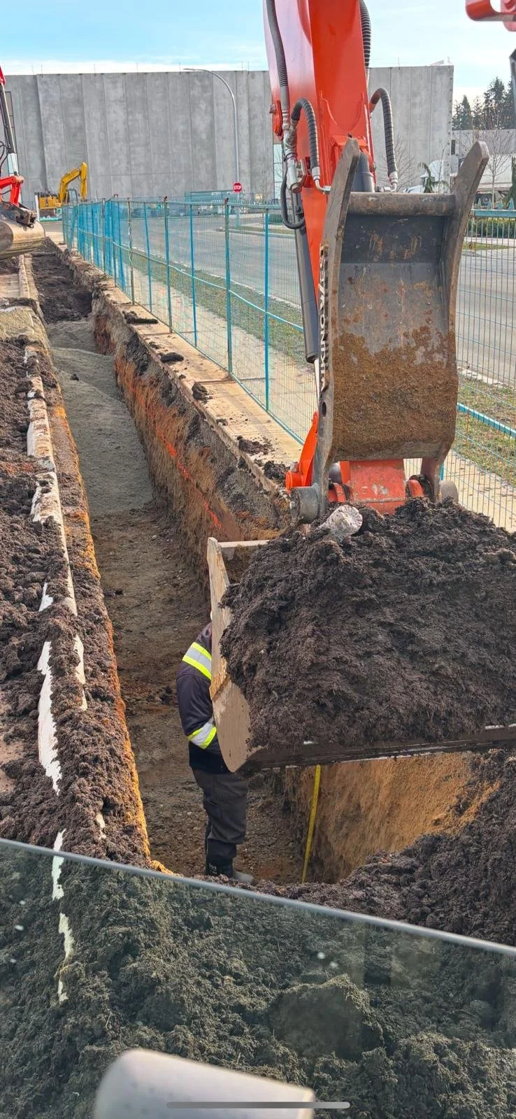 Excavator digging trench at construction site