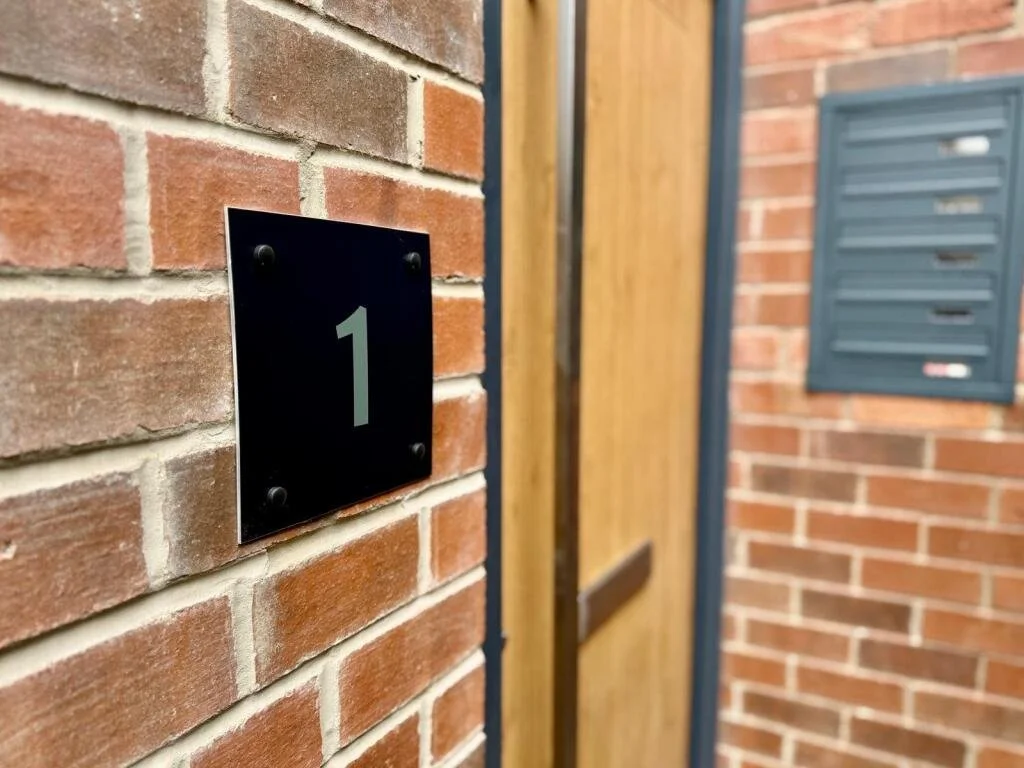 Composite golden oak front door with anthracite frame and building mailbox in wall, flat conversion, Kirkstall, Leeds