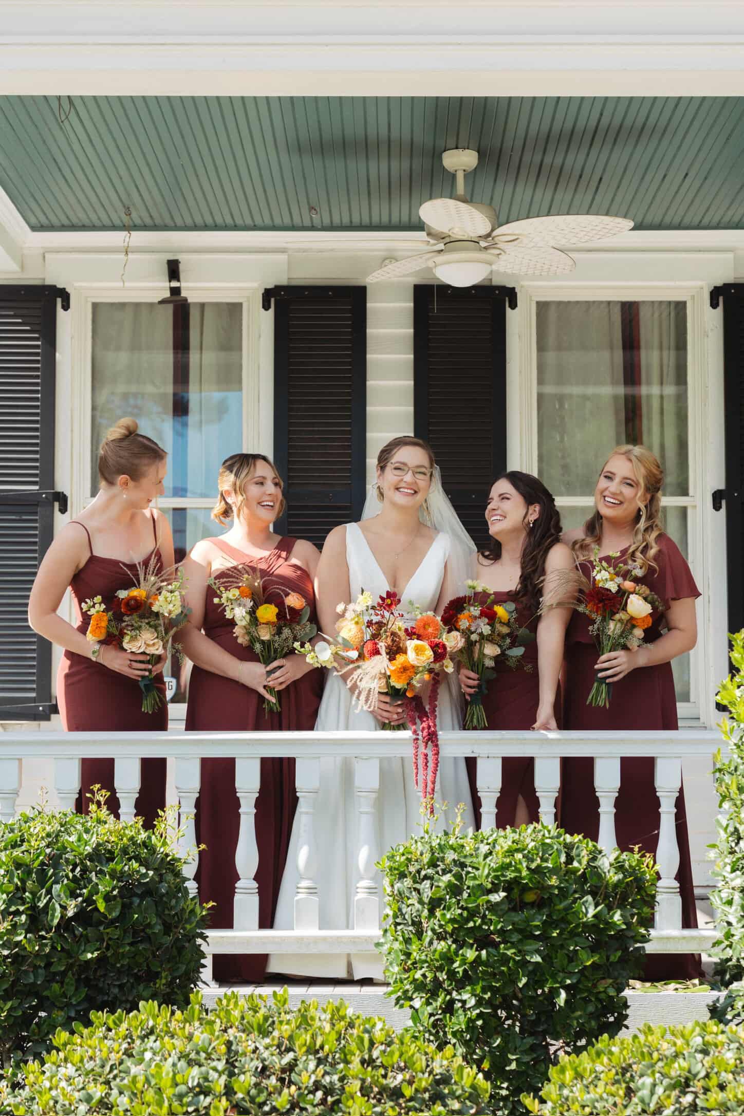 Bridal Party on balcony holding flower