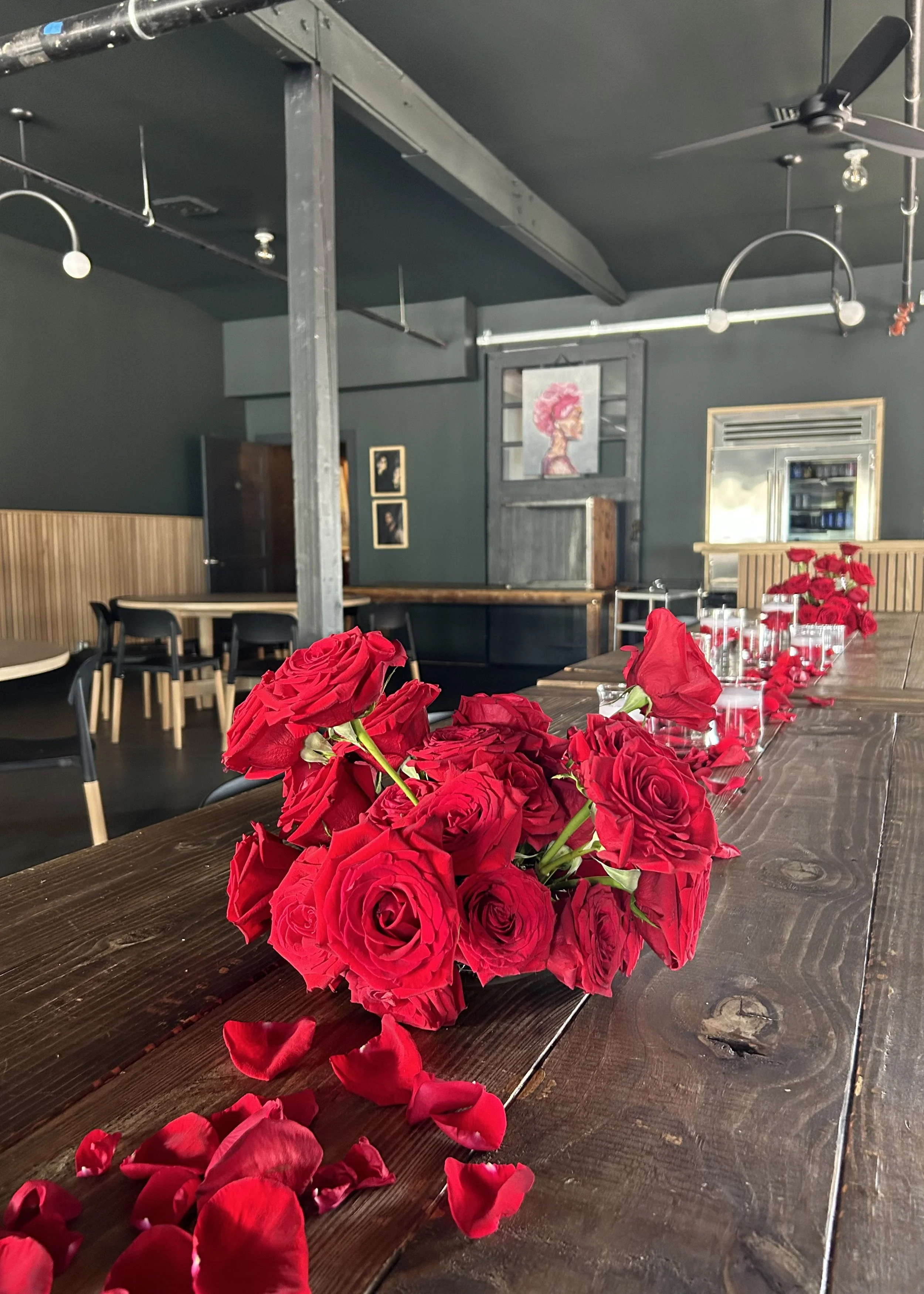 Red rose arrangements on a long table