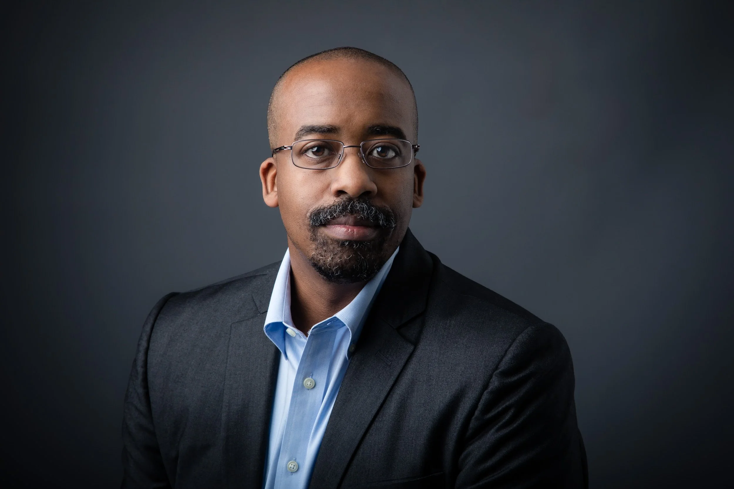 High-quality studio headshot with clean background, ideal for executives and creatives