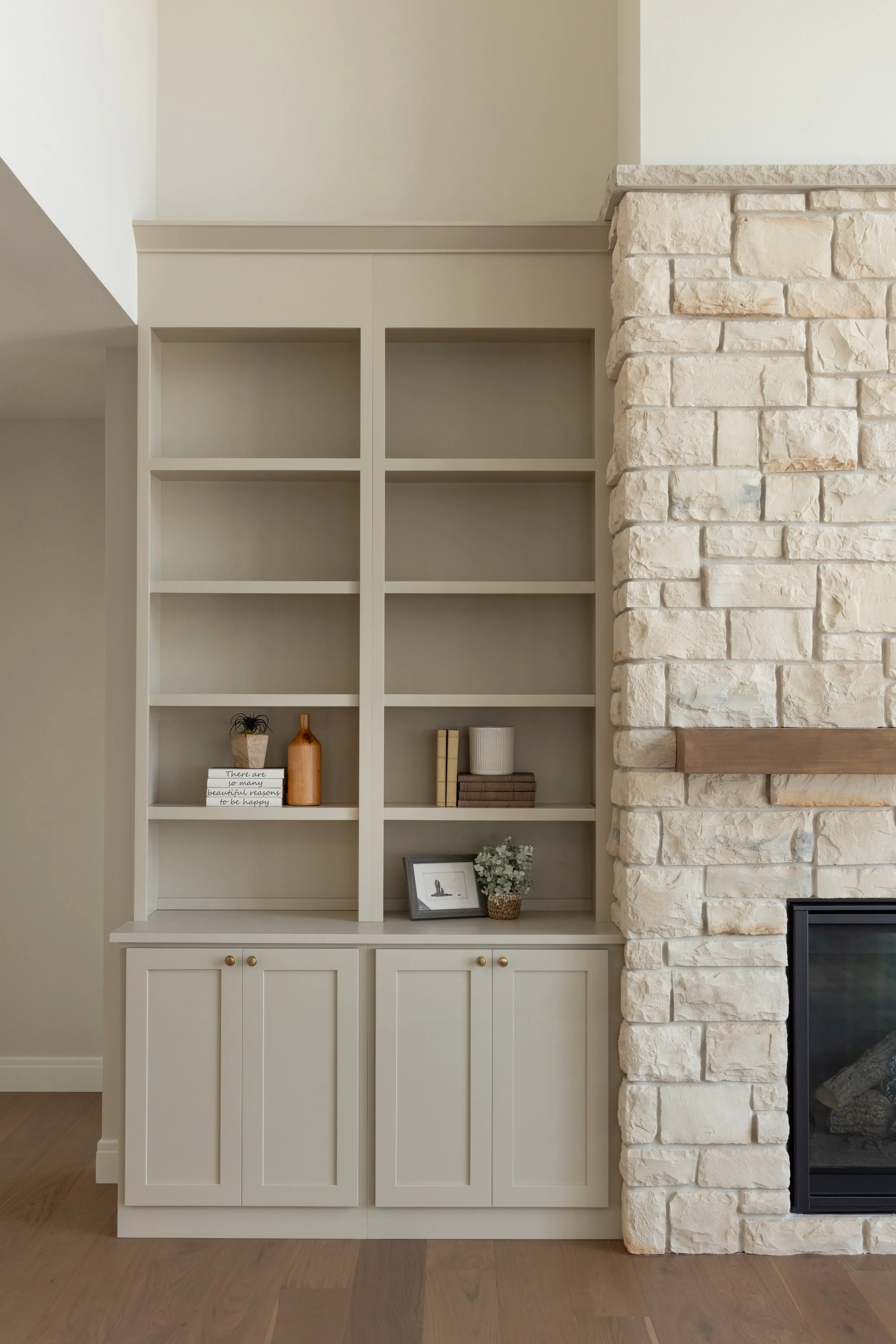 Light wooden built in shelf on the side of a brick fireplace