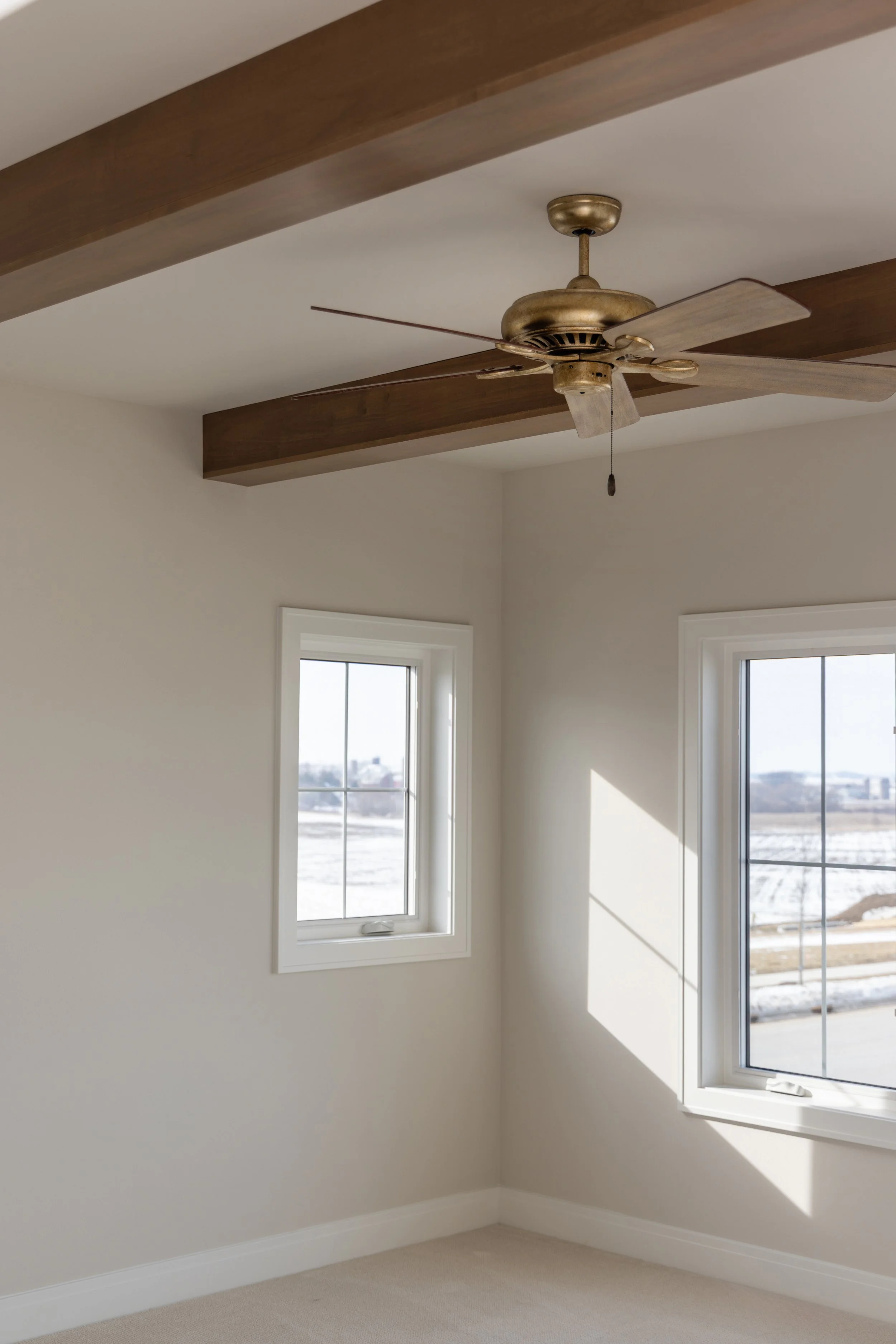 Room with wooden beams and ceiling fan