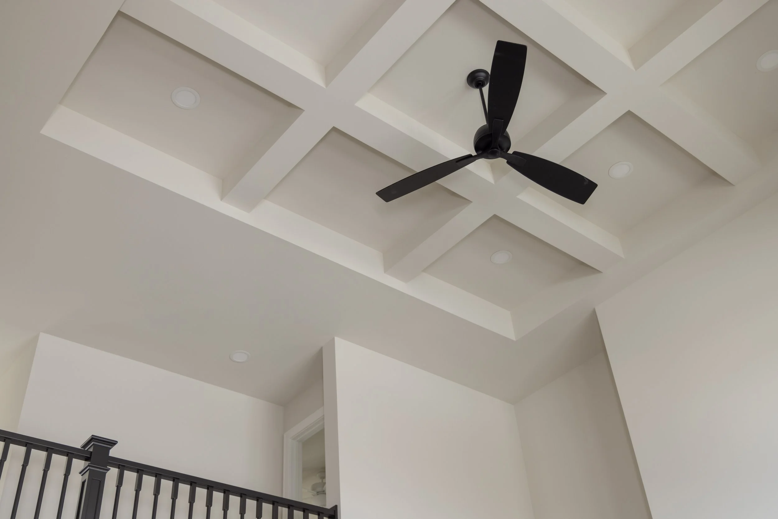 Coffered ceiling with a black three blade ceiling fan