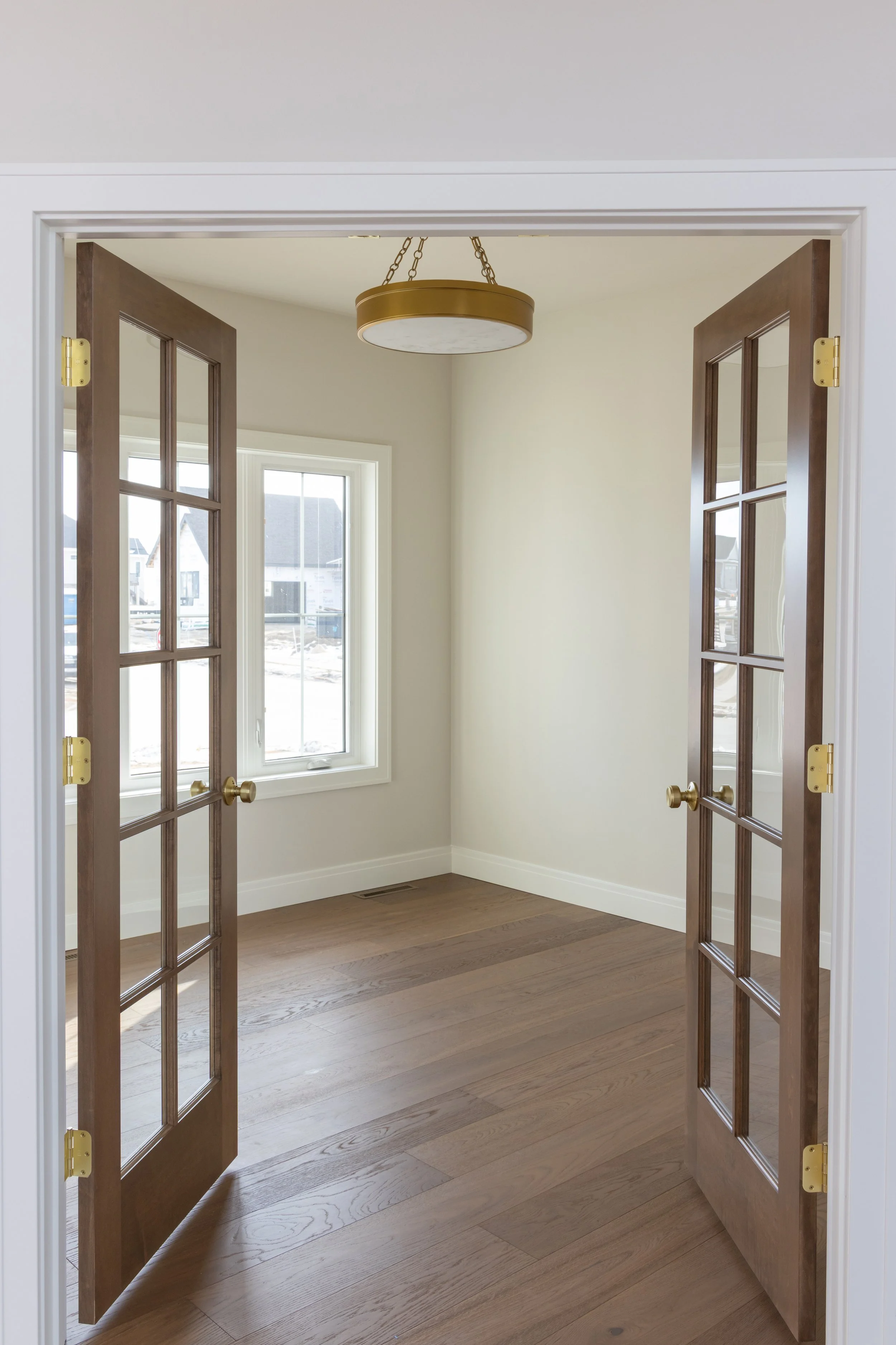 Interior french wooden doors opening to an empty room