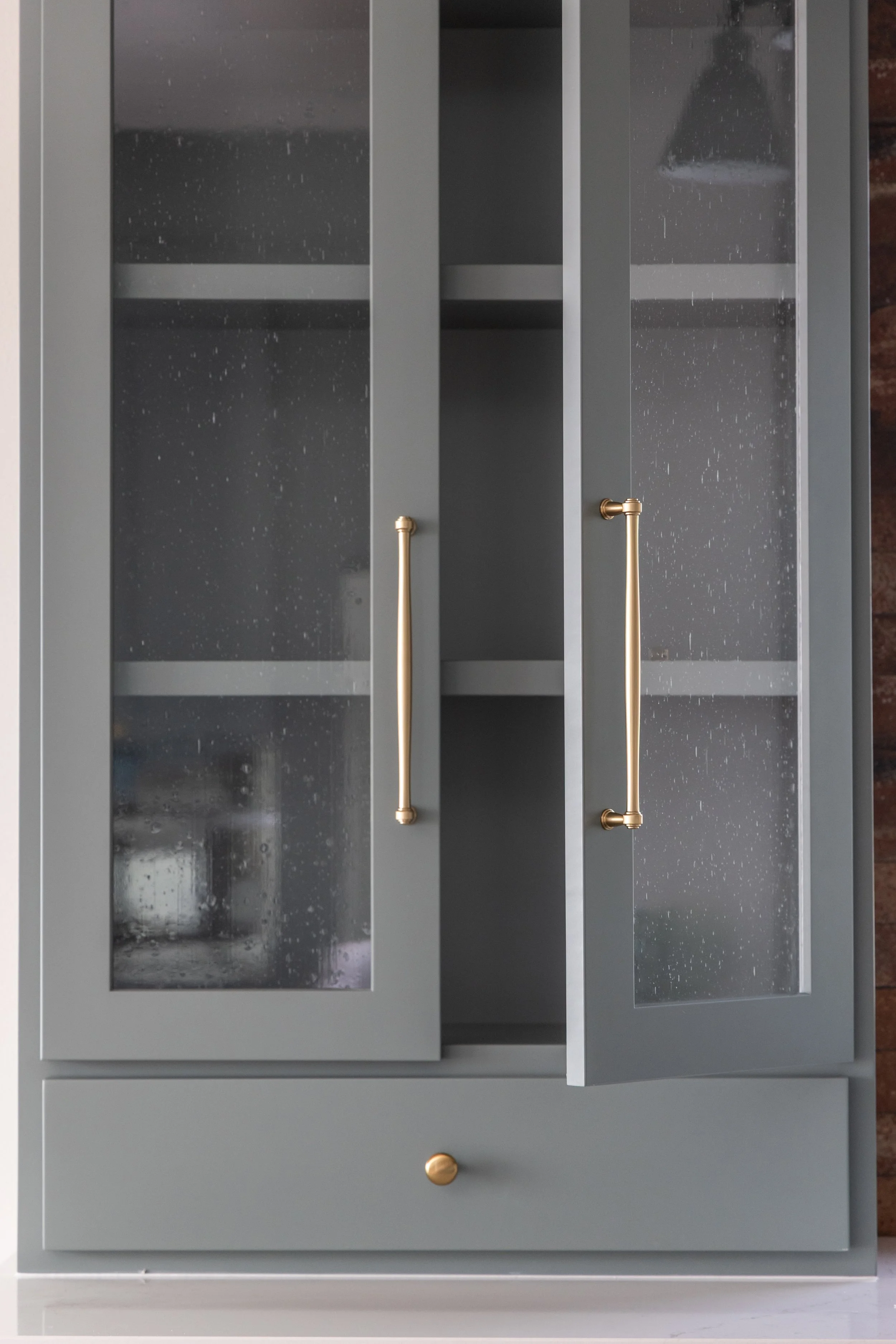 Blue kitchen cabinets with glass panelling