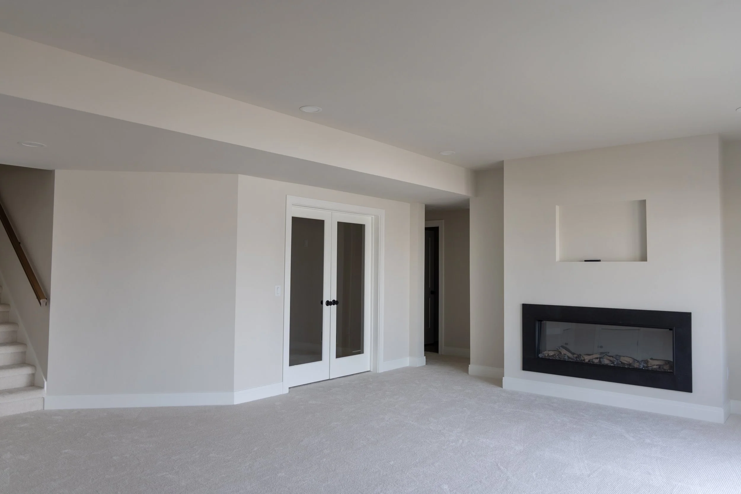 White lower level basement with fireplace