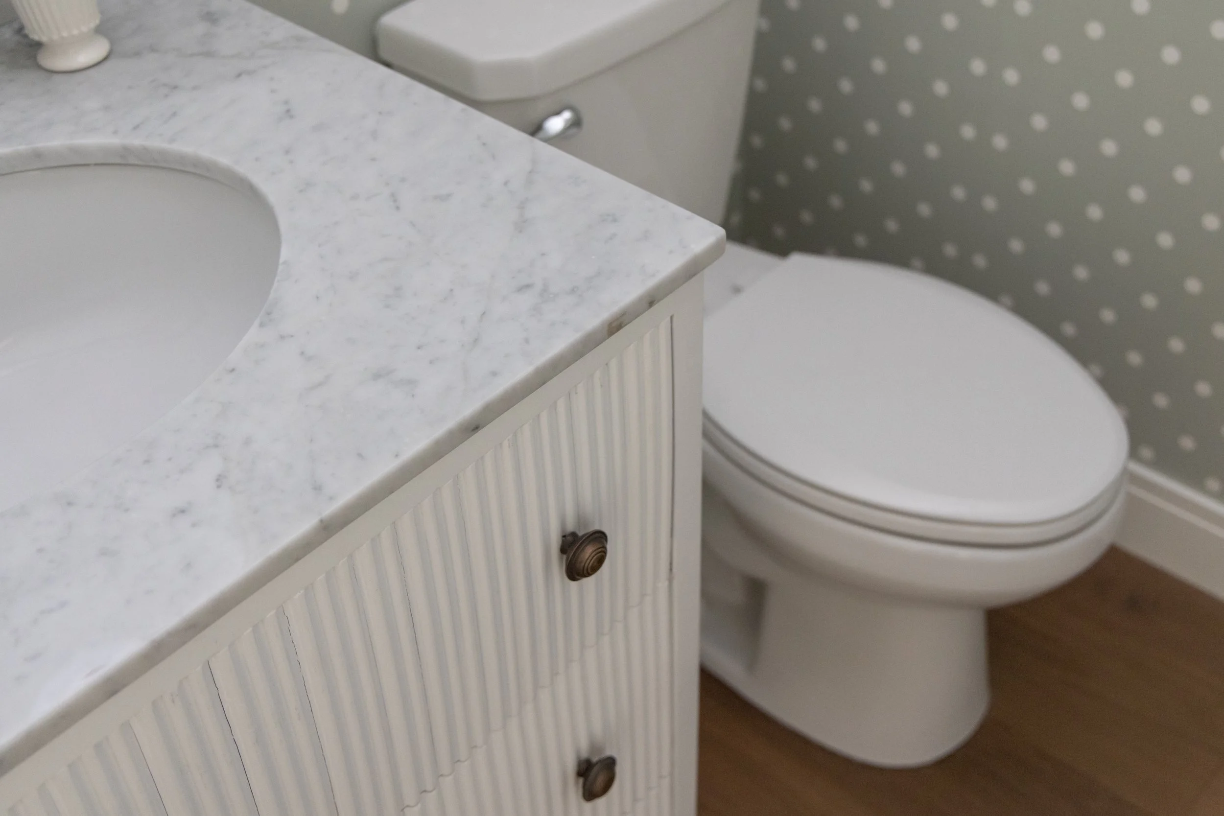 White bathroom vanity and toilet