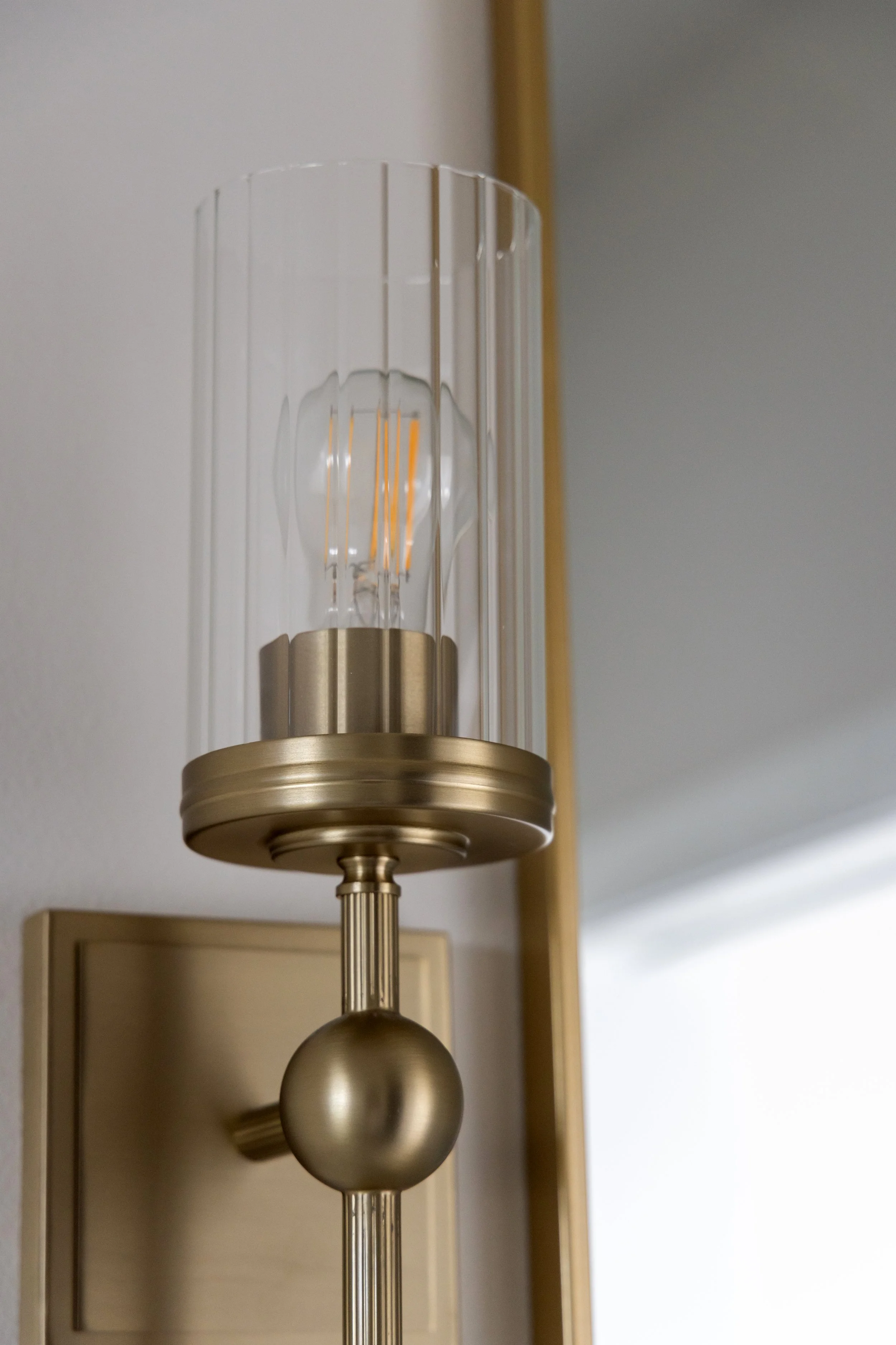 Glass and brass sconce