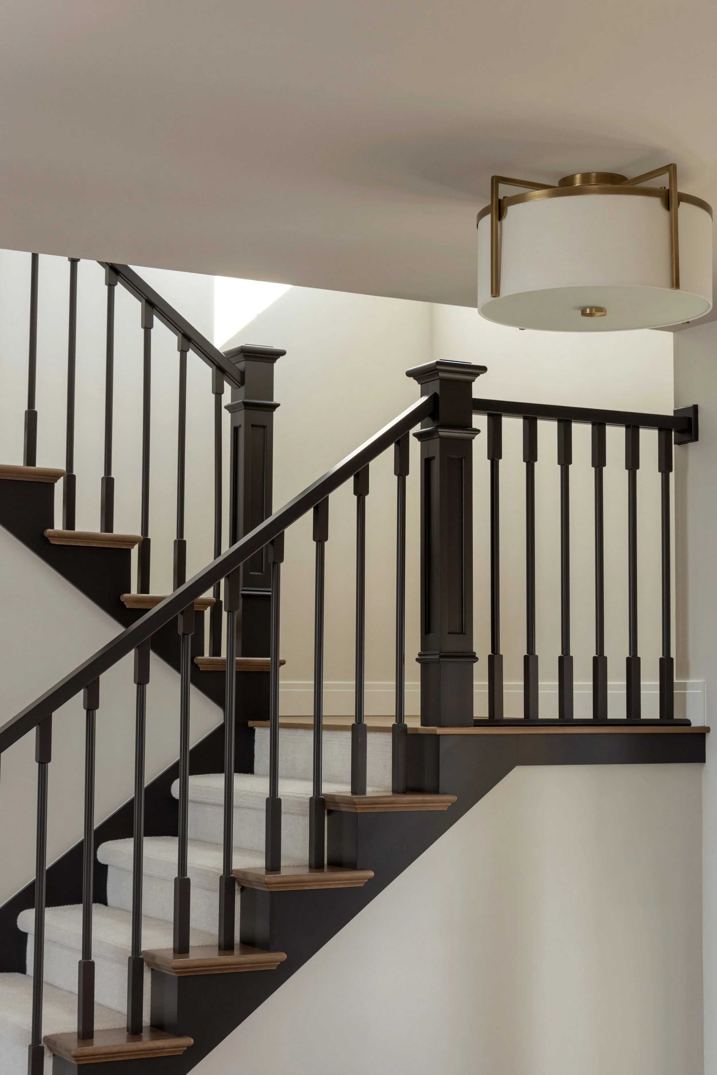Wooden stair rail with ceiling light