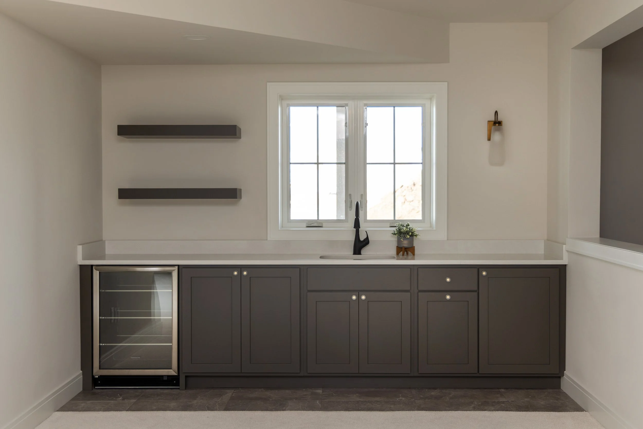 Wooden wetbar in room with a window