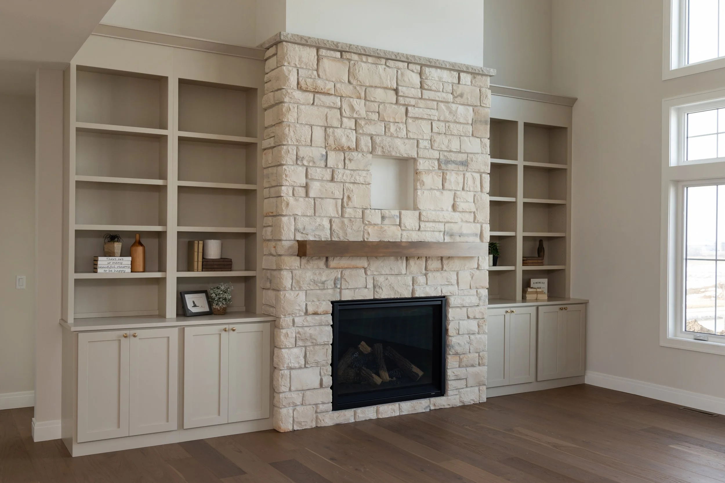 Light brick fireplace with built-in shelves on both sides