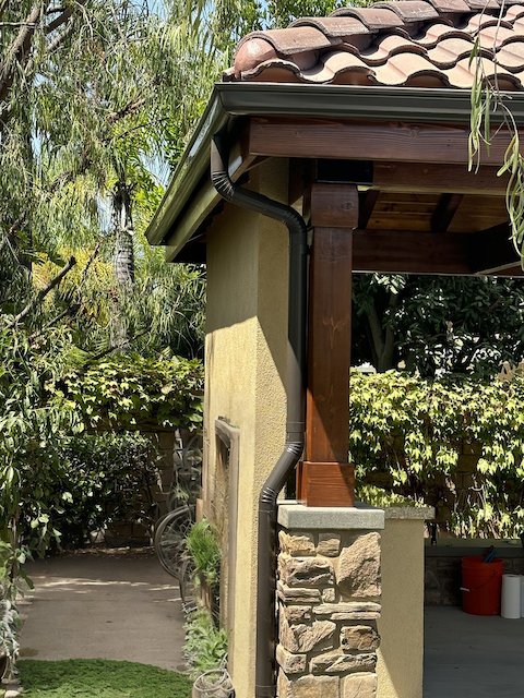 Downspout and gutter detail protecting home exterior