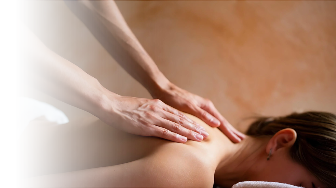 A person receiving a massage on their back from a massage therapist.
