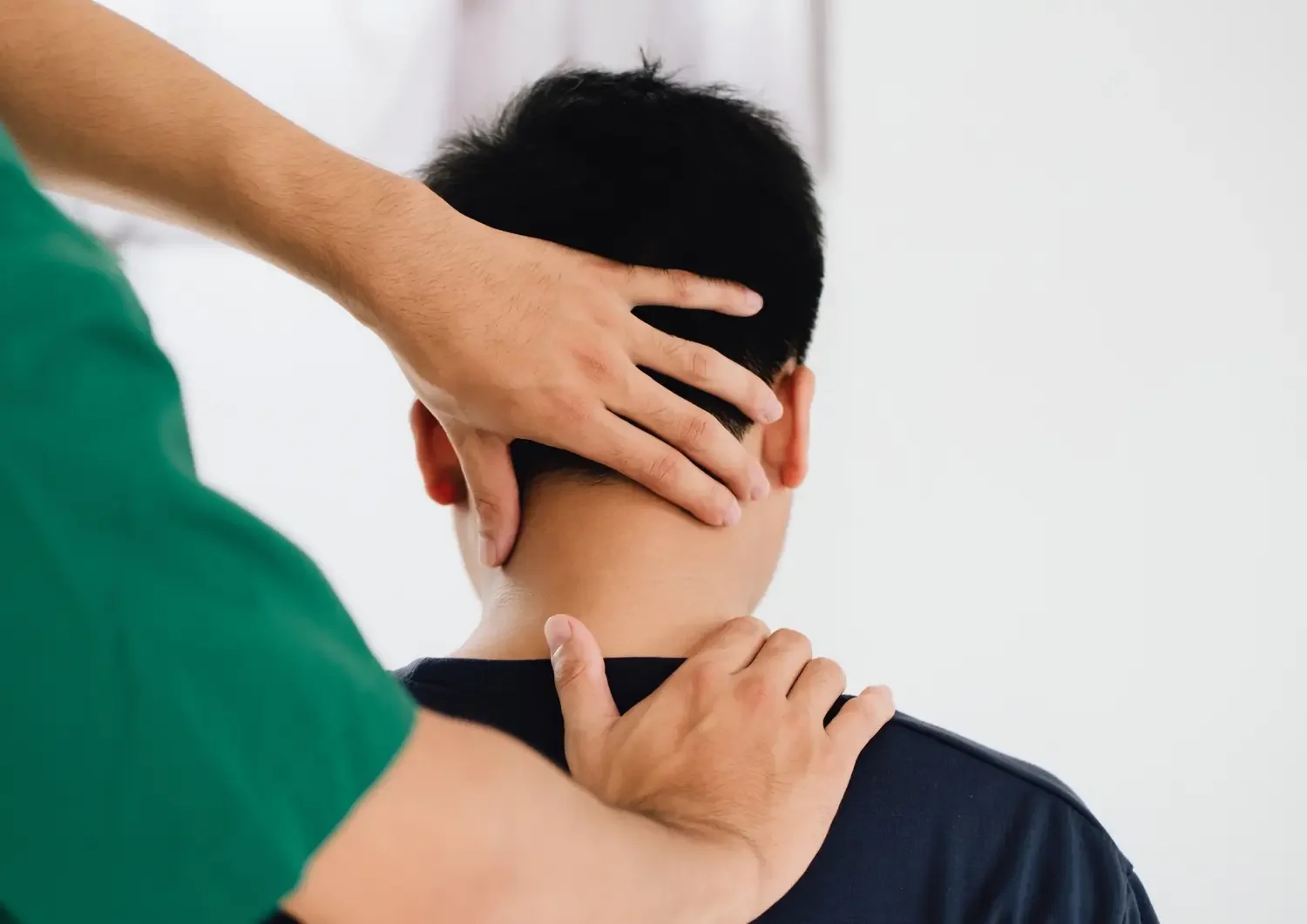 Massage therapist assisting client with postural correction to relieve slouching, tight shoulders, and misalignment