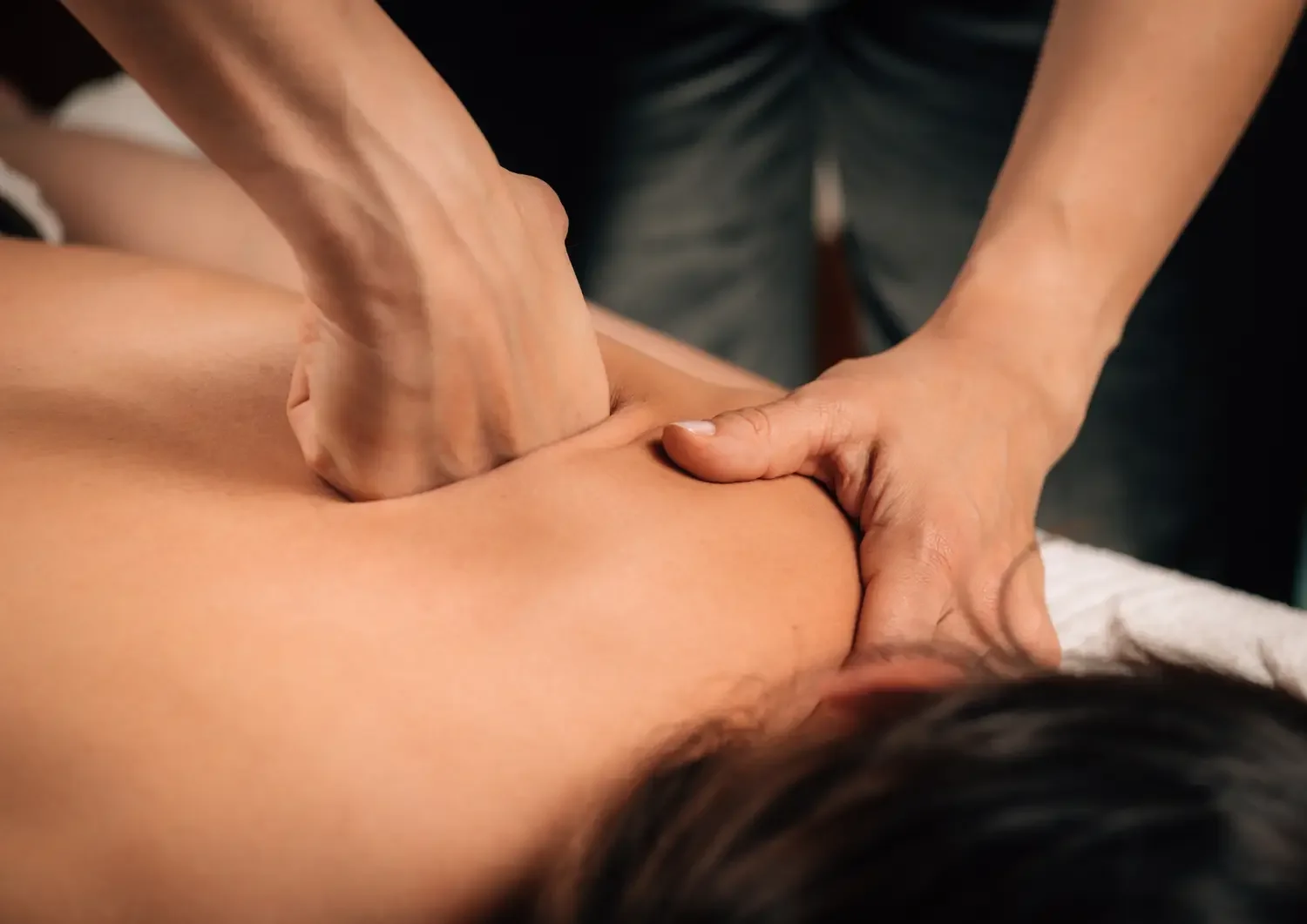 Deep tissue massage with strong pressure to relieve chronic pain and tension in deep muscle layers