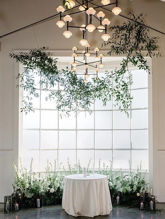 Floor florals may seem subtle, but they play a powerful role in shaping the atmosphere of your ceremony or reception. Whether lining the aisle, framing a vignette, or softening architectural edges, these low arrangements add depth, romance, and dimen