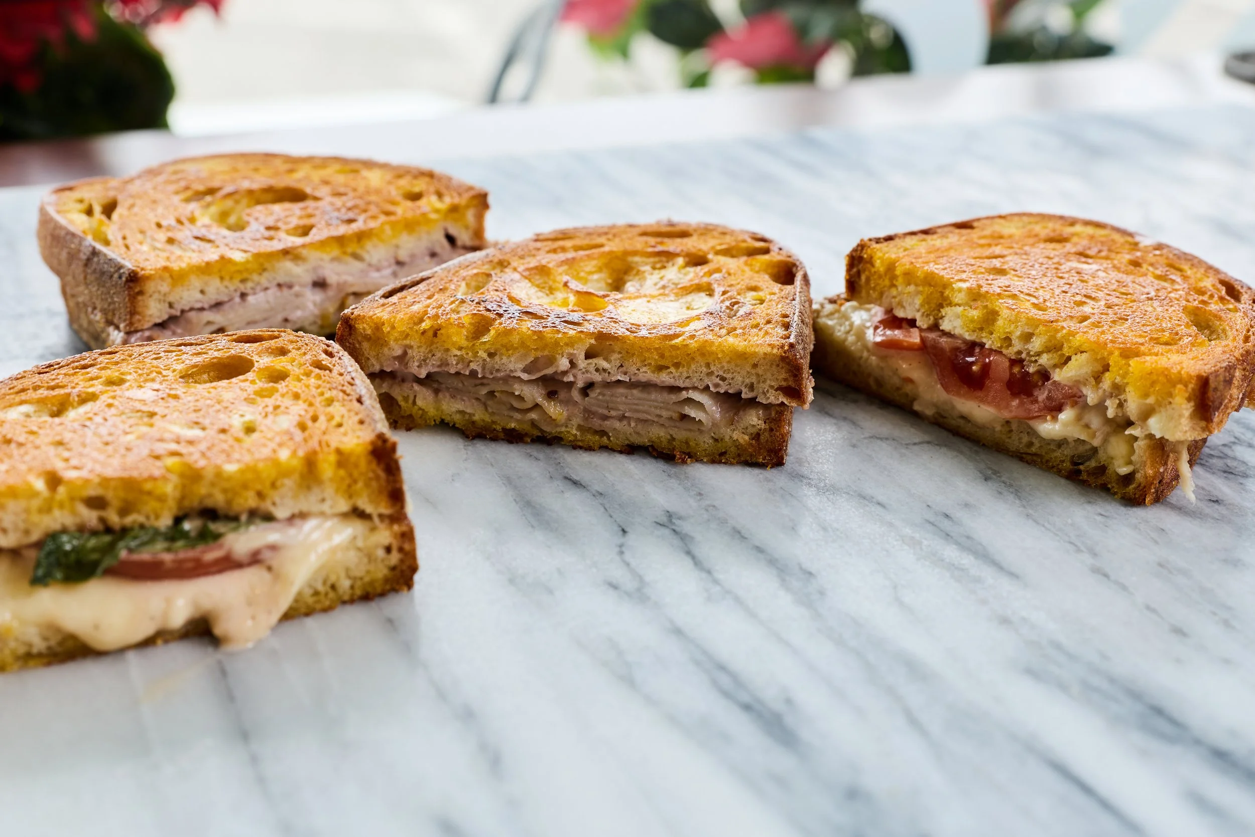 Four pieces of sandwiches with various fillings.