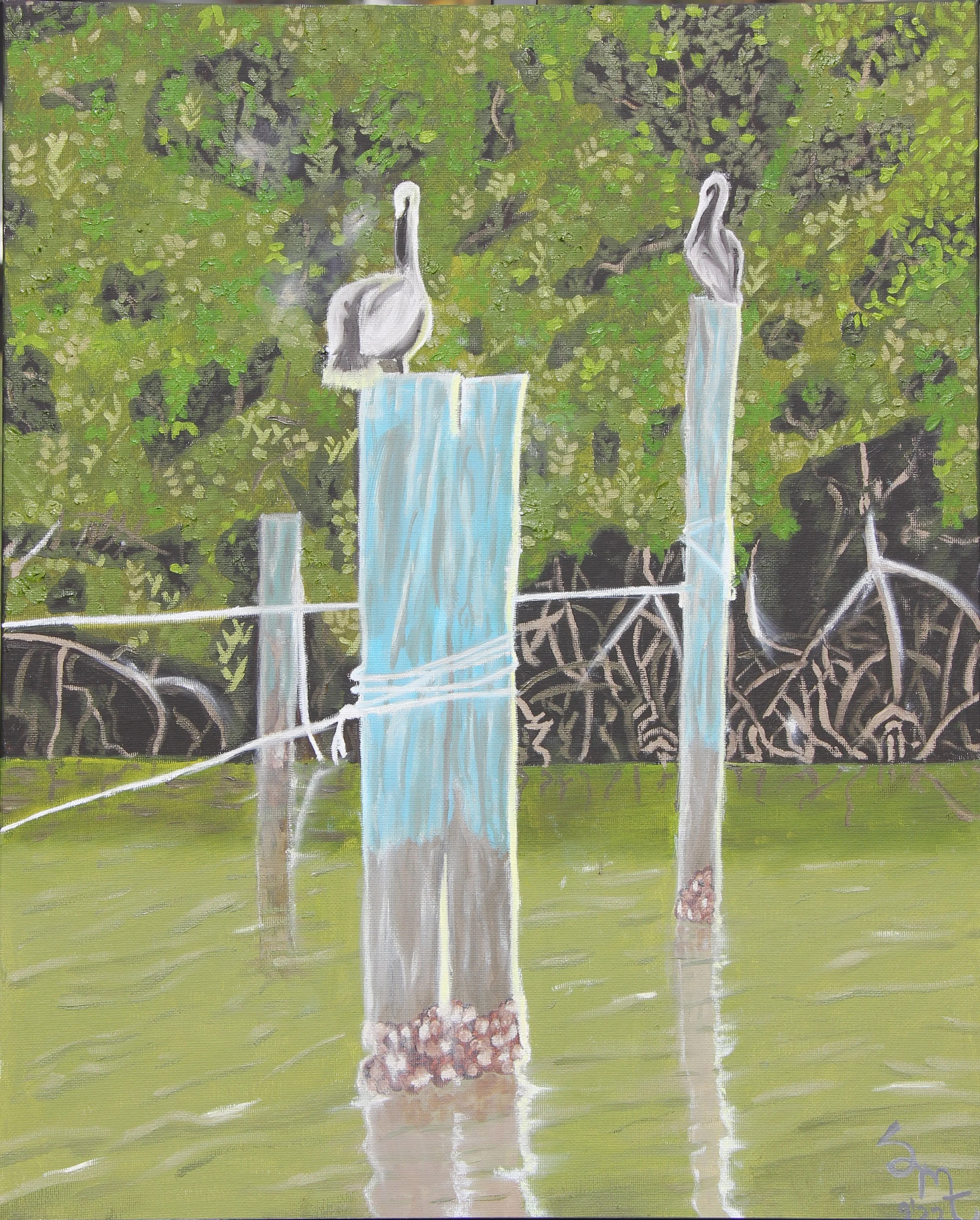 Two Pelicans sitting atop the pilings in Captiva Florida in front of Mangroves