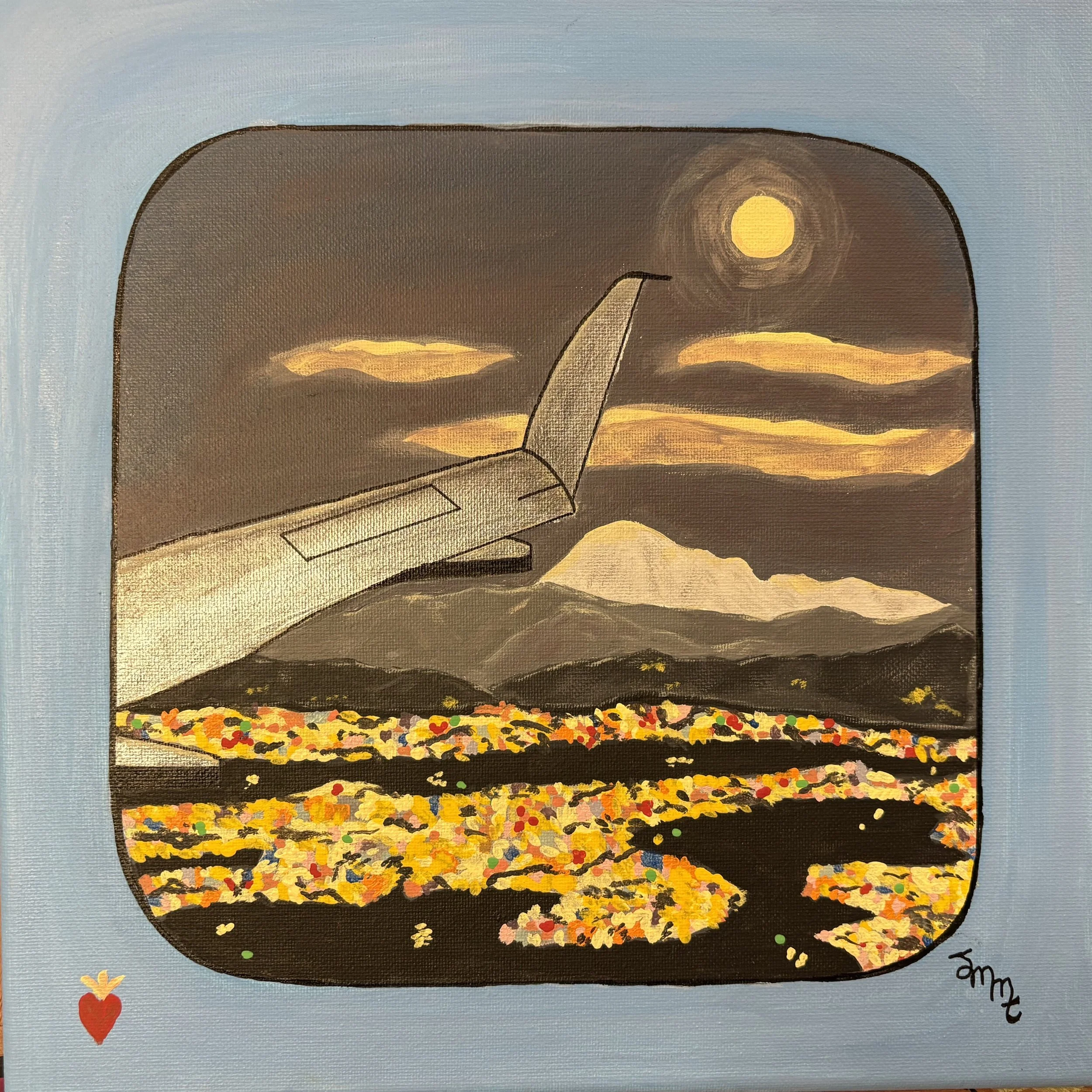 The view of a city as you fly over it at night with mountains and moon and clouds in the sky