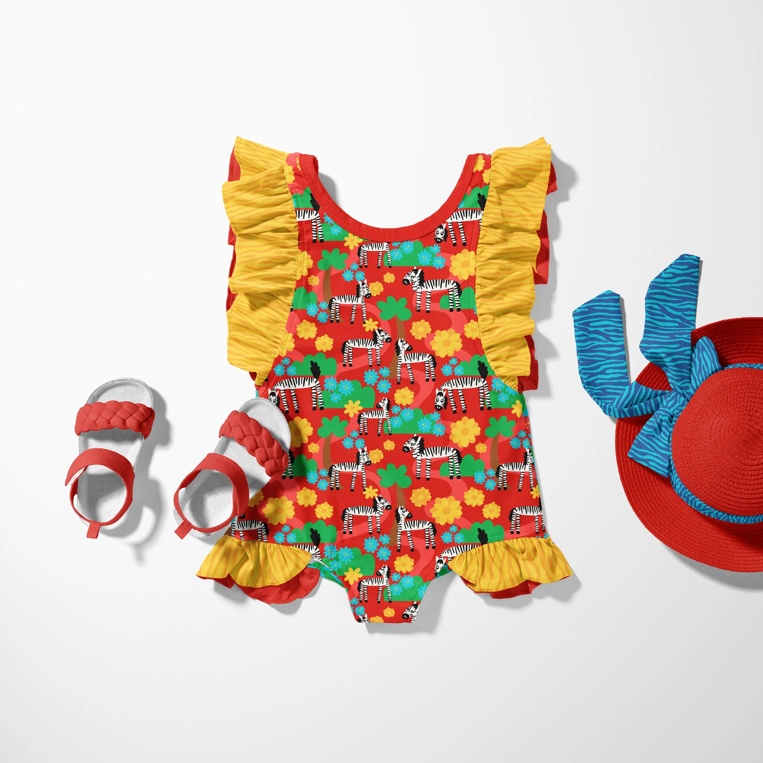 little girls ruffled bathing suit featuring zebras in bloom red fabric with yellow floral ruffles. playful zebra fabric collection