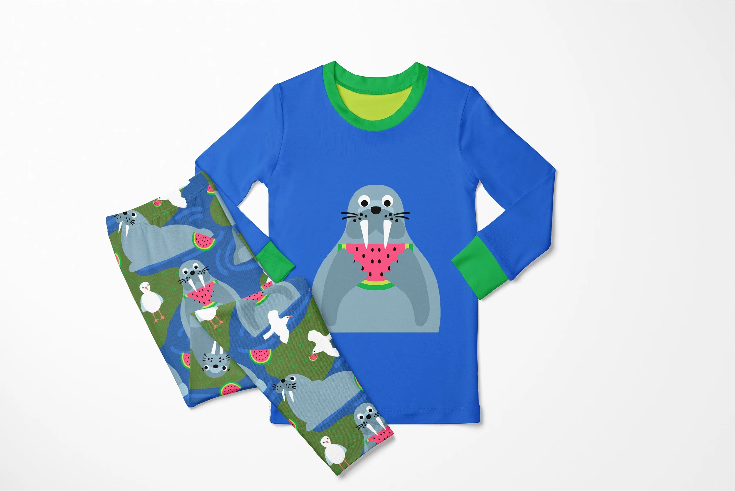 bright blue childrens pajamas featuring happy fun whimsical walrus eating watermelon on short. patterned pajama pants hae playful, happy walrus and seagull pattern at the coastline. art available for art licensing
