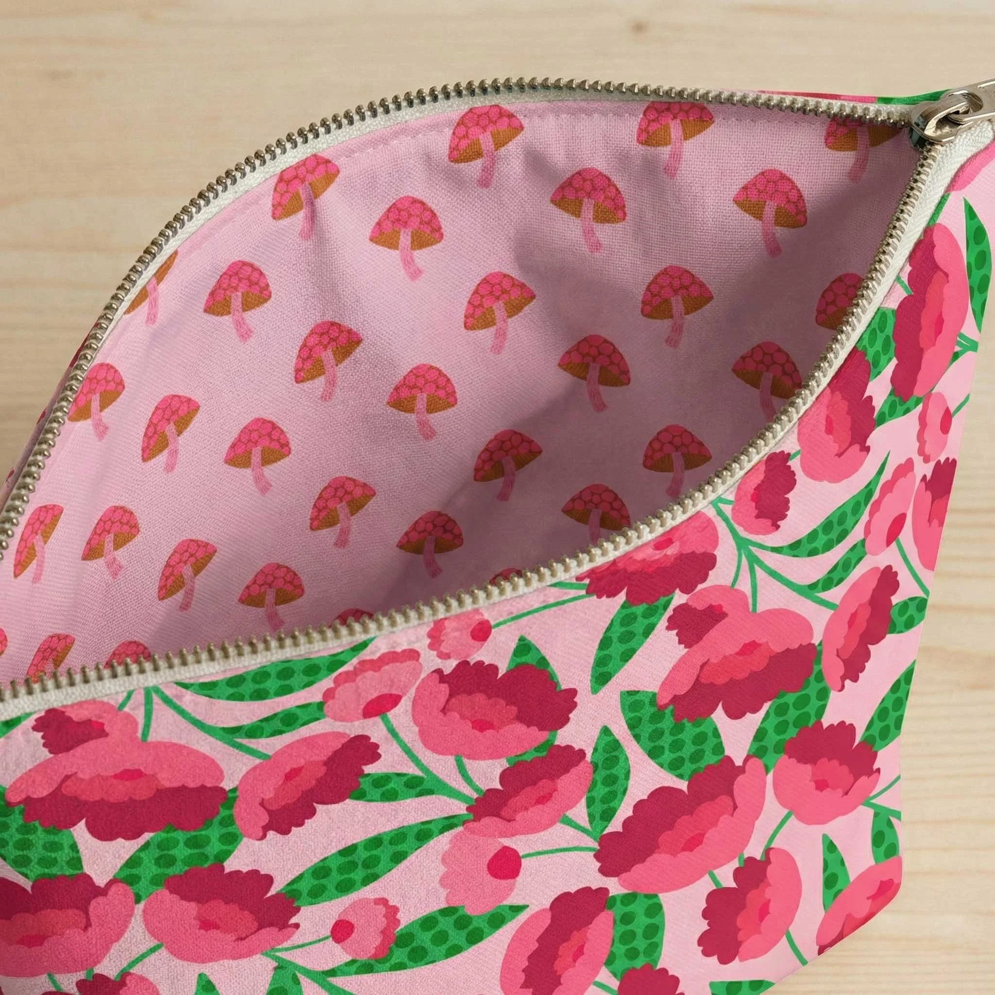 zippered makeup bag with fluffy pink peony flower pattern as exterior and mushroom pattern as lining
