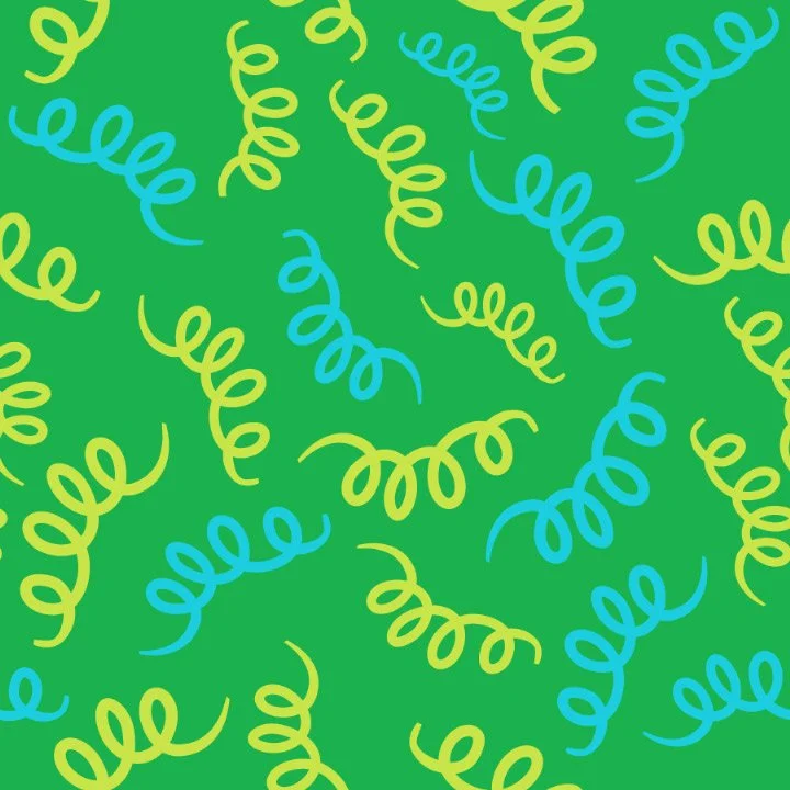 Colorful birthday streamers on a green background