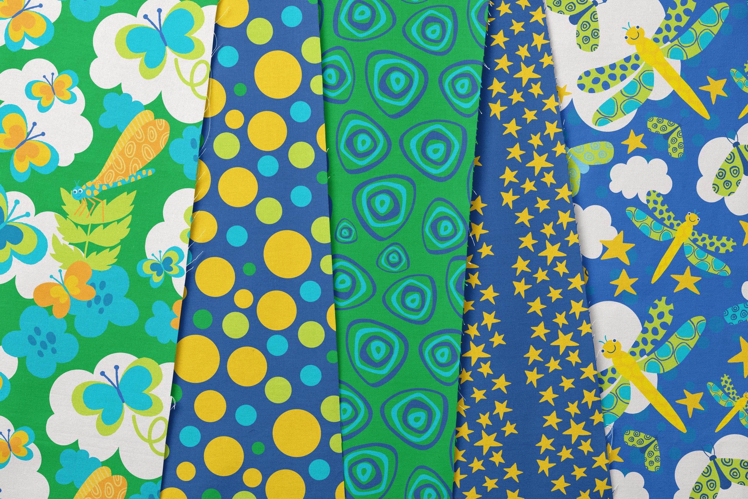 A collection of colorful patterned fabrics with designs featuring butterflies, ladybugs, dragonflies, and stars in shades of green, blue, yellow, and white.