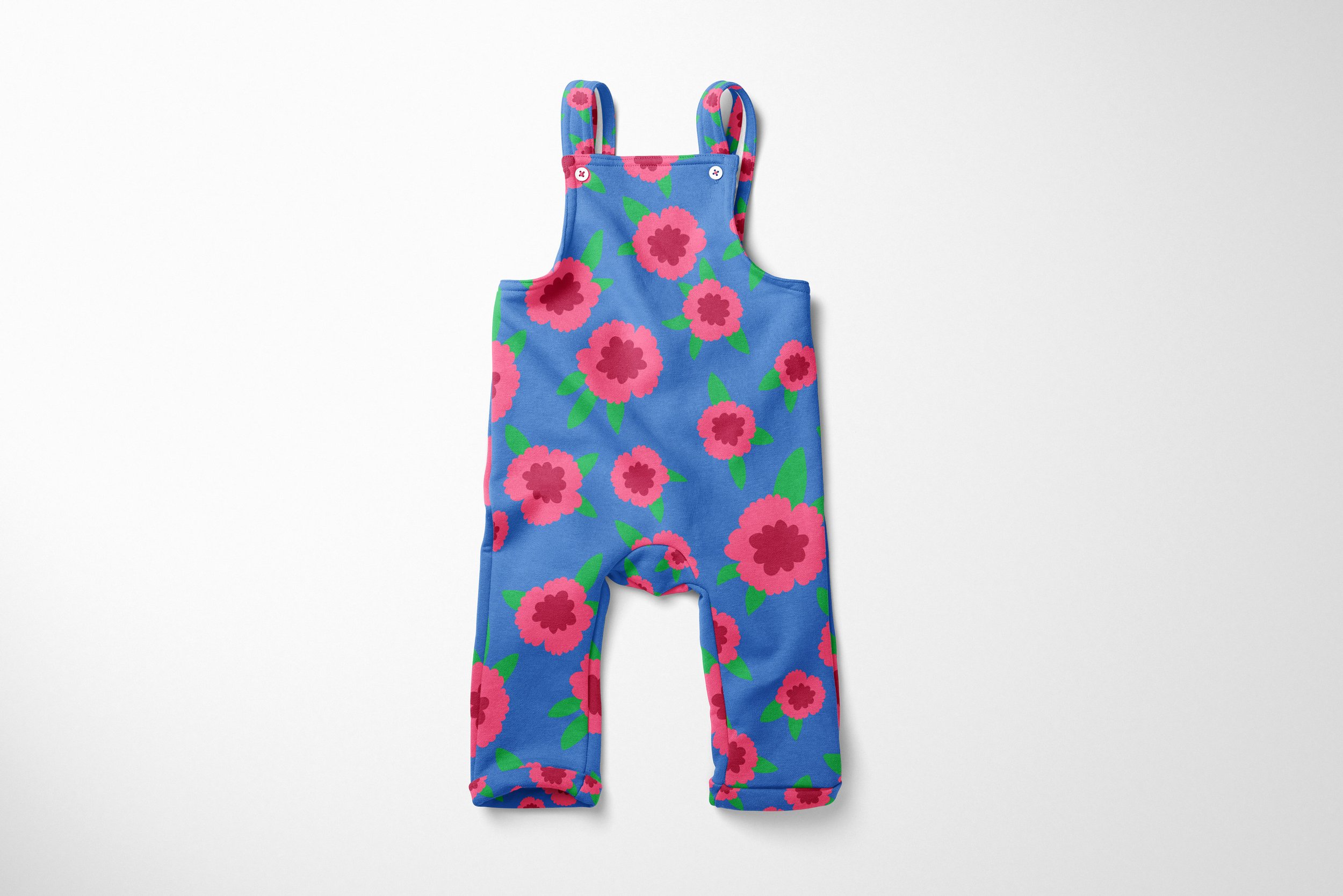 toddler overalls featuring a bold, graphic poppy print. The design showcases large-scale pink and red poppy flowers with dark centers and green leaves set against a bright blue background. The overalls have a bib style with white buttons and rolled c