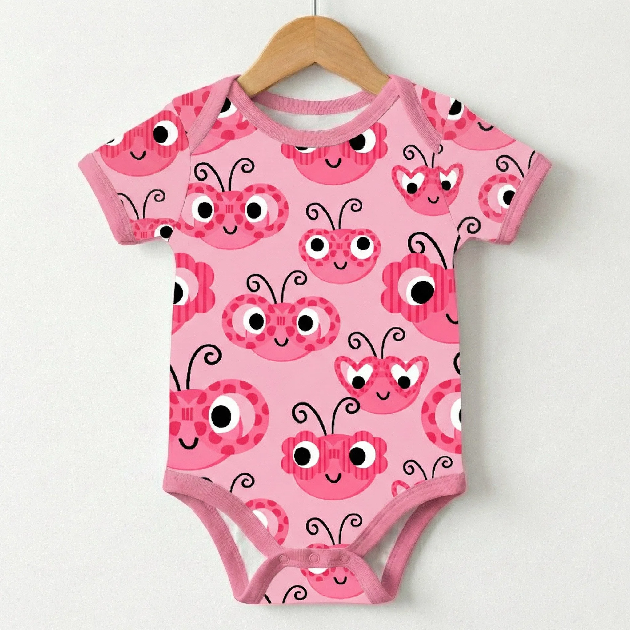 Baby onesie showcasing playful heart-shaped ladybug character artwork from the Love and Ladybugs collection. Whimsical surface design created for baby apparel, children’s clothing, and joyful textile licensing inspired by love, nature, and cheerful s