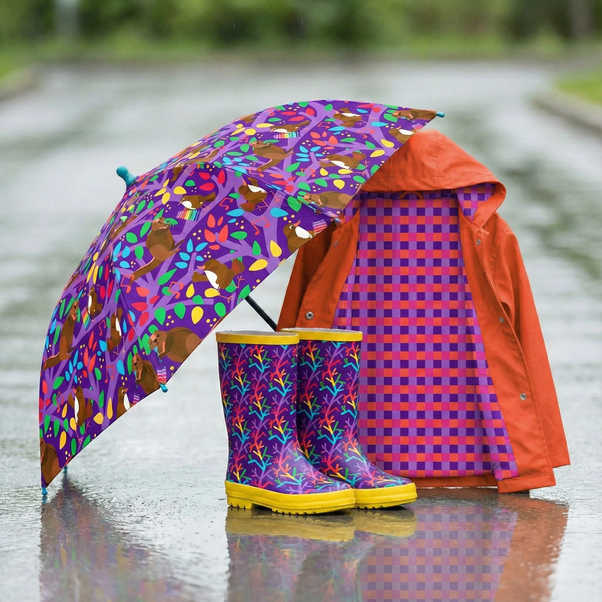 umbrella, rainboots and rainjacket in bold colorful prints designed by hazela and henrietta. singing birds, squirrels singing and dancing with trees and leaves.  Colorful music festival pattern in trees of the jungle. boots with funky tree pattern. i