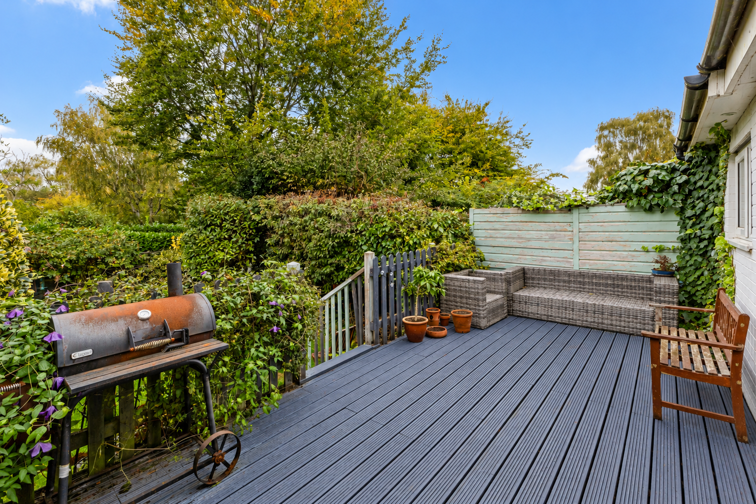 Lush Garden Deck with BBQ and Seating.png