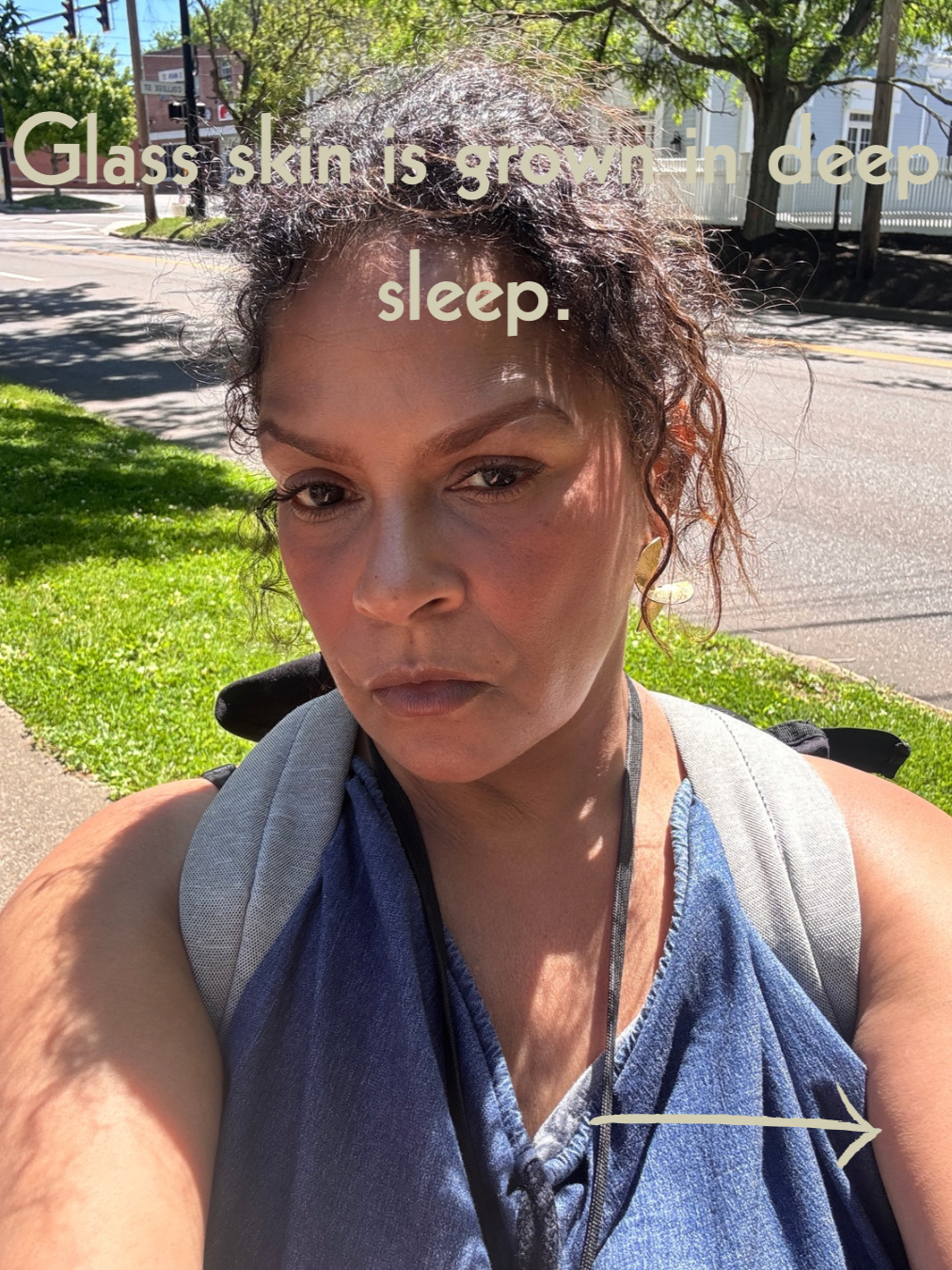 Keenya Willis taking a natural light outdoor selfie with text overlay reading Glass skin is grown in deep sleep representing the connection between quality rest and radiant skin