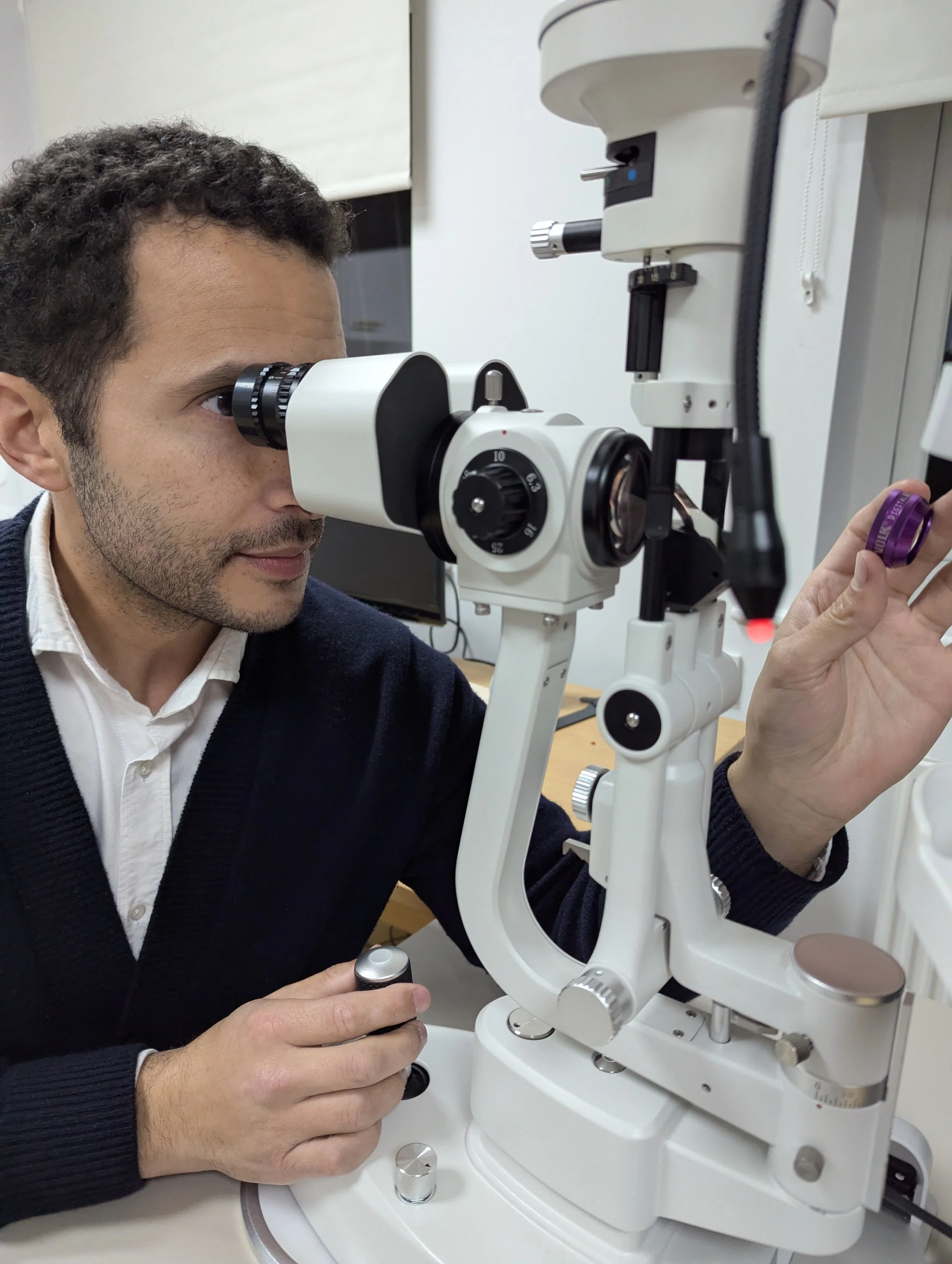 An Ophthalmologist using a slit lamp to examine an eye