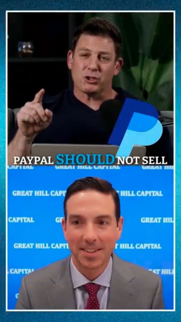 Split screen video call with two men. The man at the top is speaking, with a dark background and a large green plant behind him; he is gesturing with his finger. The man at the bottom is smiling, wearing a gray suit and red tie, with a blue backgroun