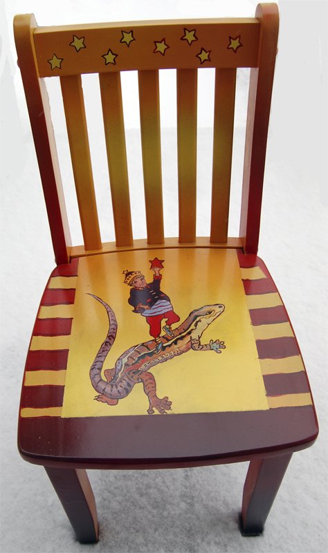 Children's wooden chair painted with a colorful circus theme, featuring a clown and a dinosaur.