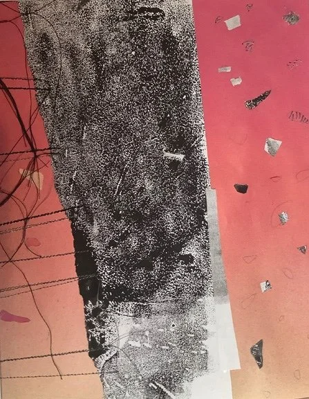 A photo of a textured black and white surface with scattered pieces of foil and small objects on a pink background.
