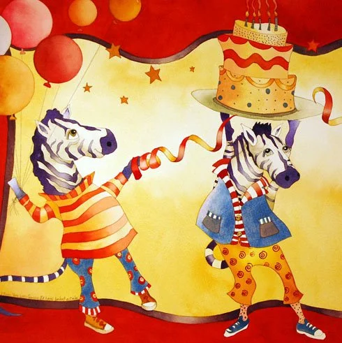 Two zebras dressed as clowns in a circus, balancing a birthday cake with candles on their heads.